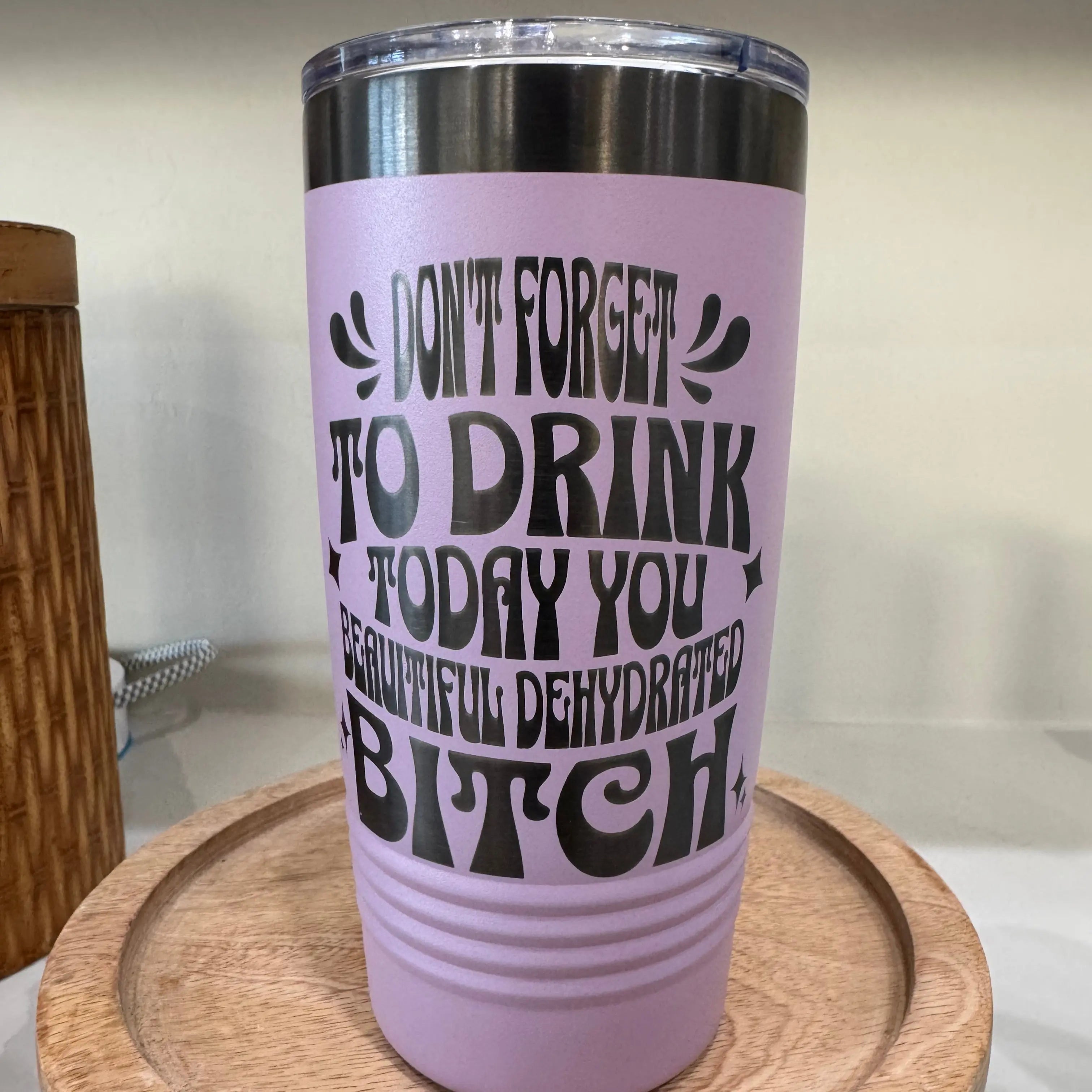 Lifestyle shot of 20oz stainless steel tumbler - travel drinkware cup perfect for commutes, gym, and everyday hydration