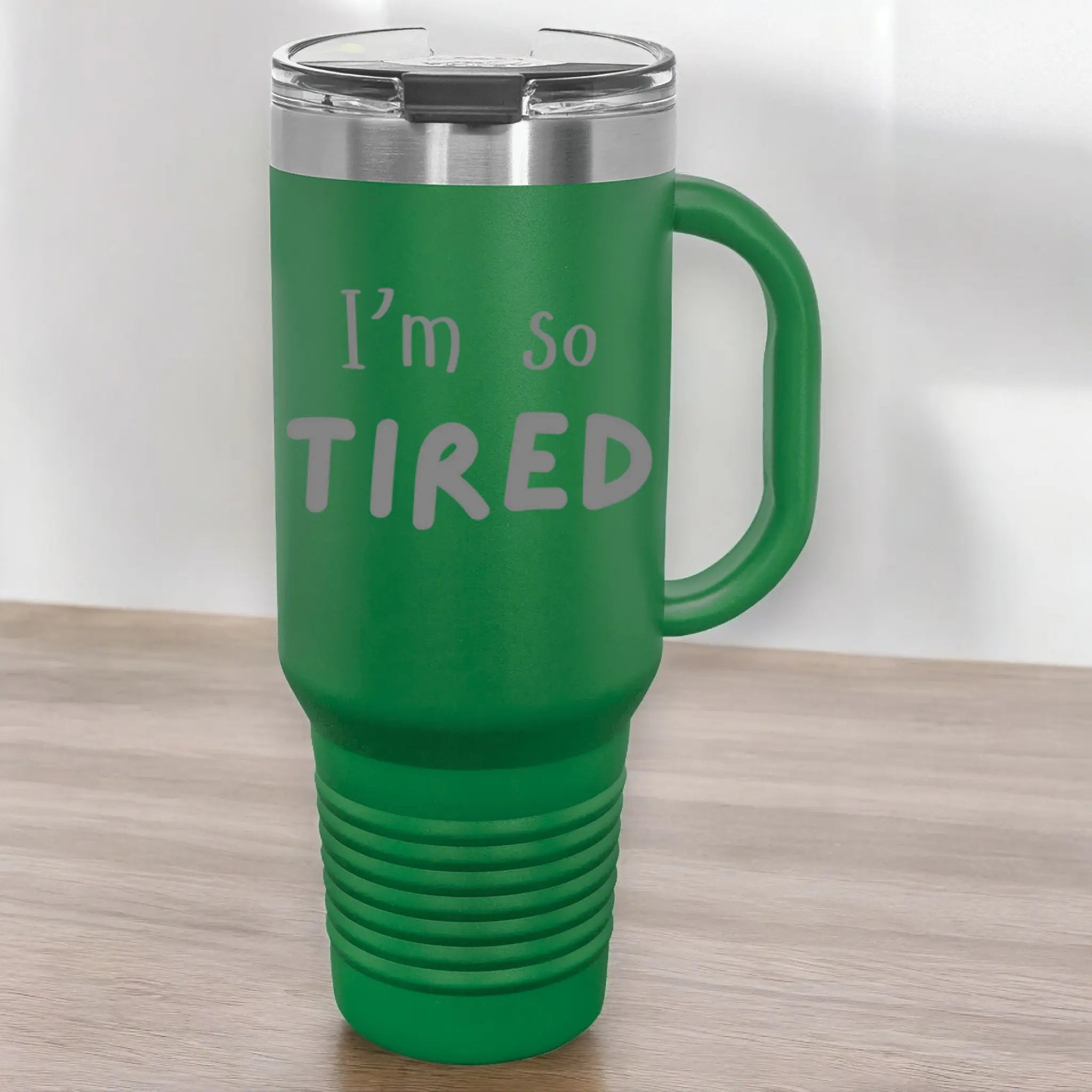 Hand holding 40oz laser engraved "I'm So Tired" tumbler in green- lifestyle exhausted cup with handle for perpetually tired workers and parents