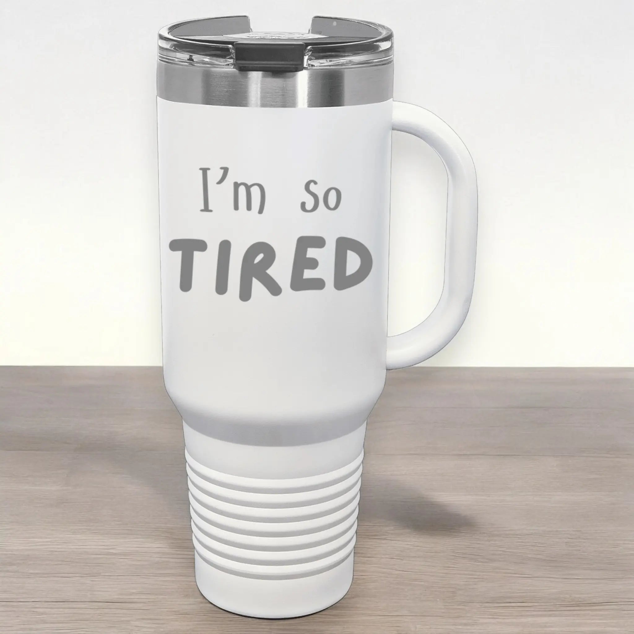 Hand holding 40oz laser etched "I'm So Tired" tumbler with straw - tired cup insulated for parents surviving on caffeine fumes