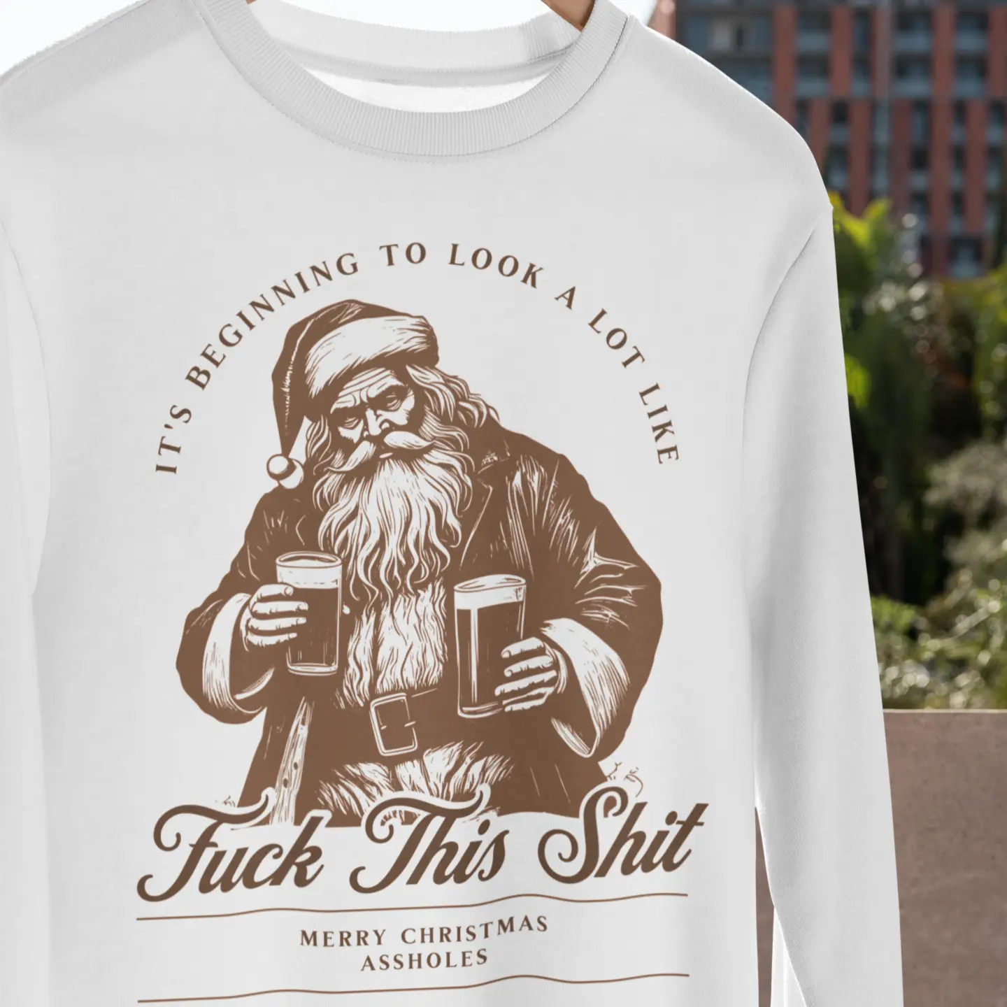 Outdoor lifestyle shot of "F*** This Shit" Christmas crewneck with Santa drinking beers - funny anti-Christmas sweater for holiday haters