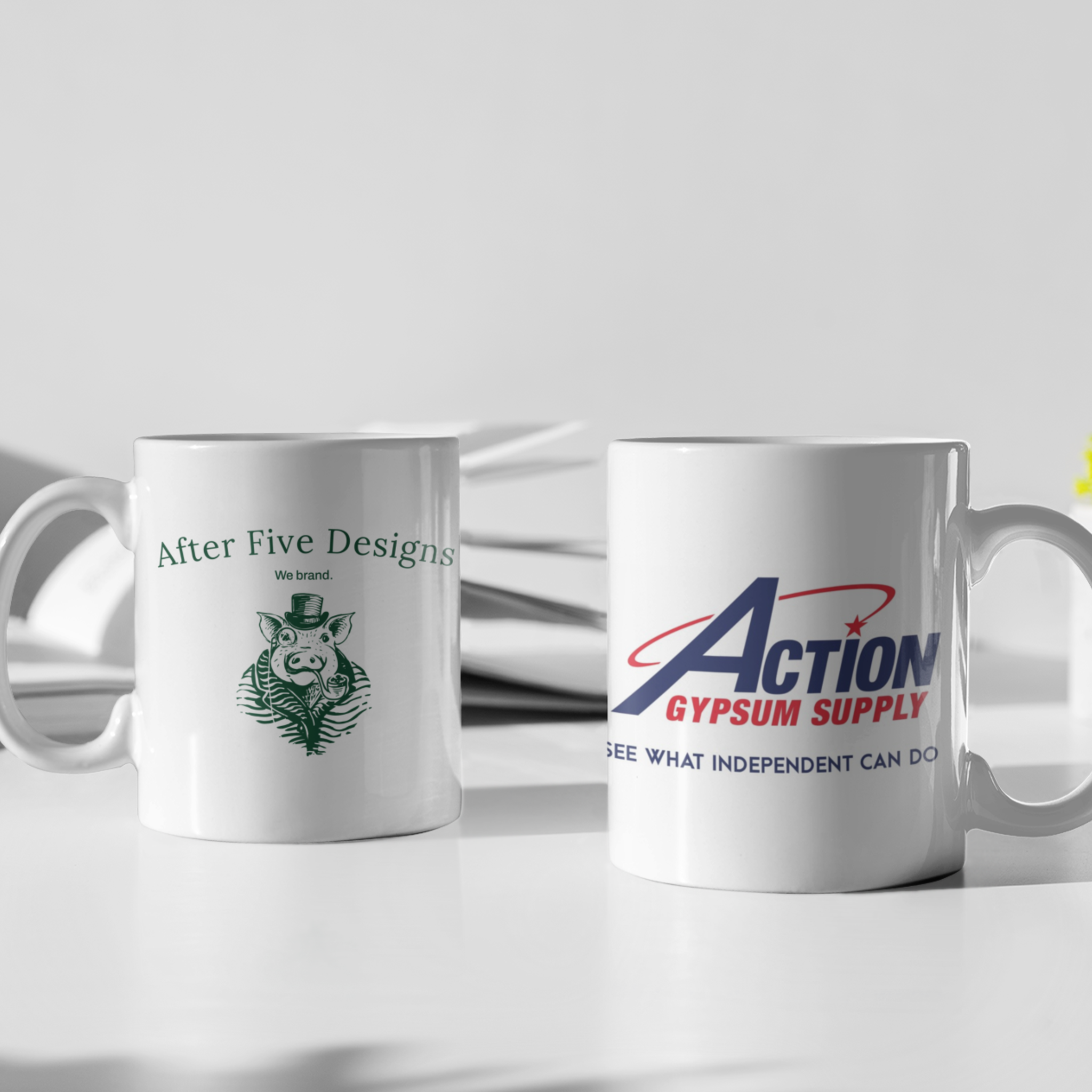 Two white mugs showcasing personalized products; one with After Five Designs logo and another with Action Gypsum Supply logo, ideal for custom brand promotions."
