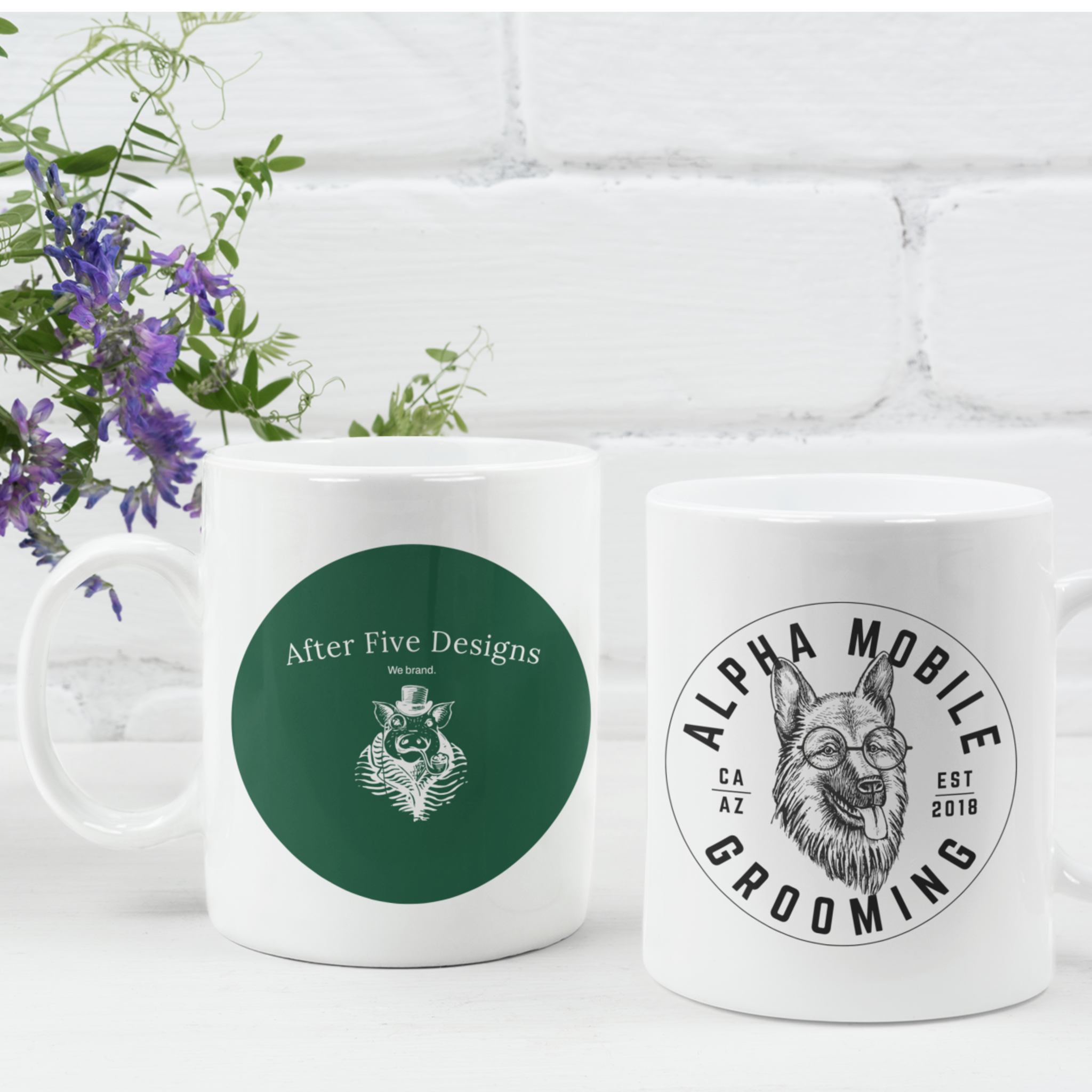 Personalized mugs with logos of After Five Designs in green and Alpha Mobile Grooming in white, displayed with a floral background for custom brand products.