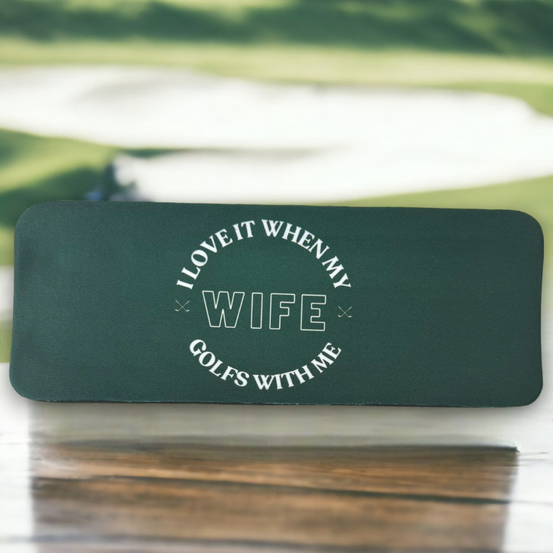 Dark green koozie with the phrase 'I love it when my wife golfs with me' printed in white, perfect as a unique gift for golfing couples