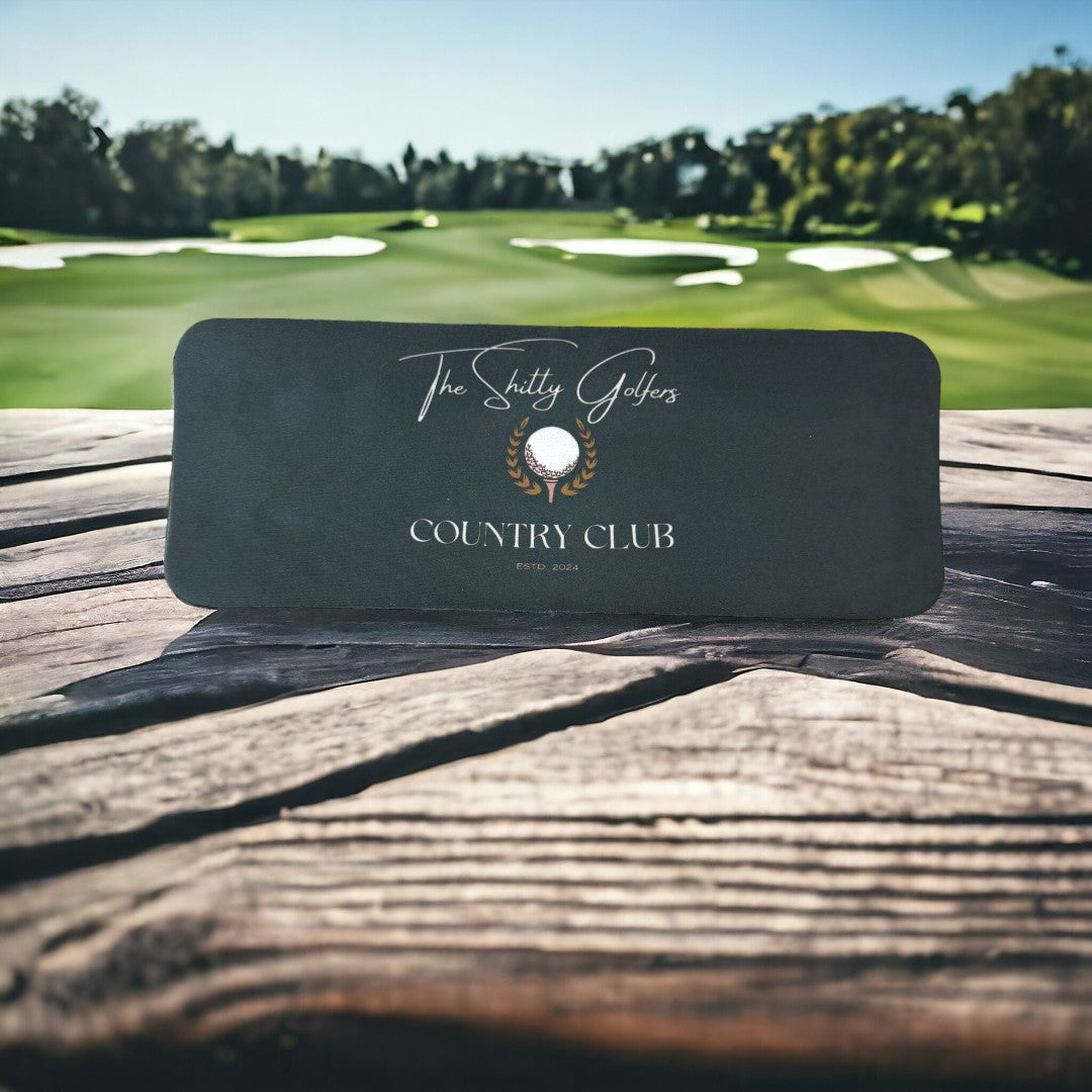 Sleek, dark koozie with the logo of The Shitty Golfers Country Club, blending style and golf humor, perfect for any golfer's accessory collection