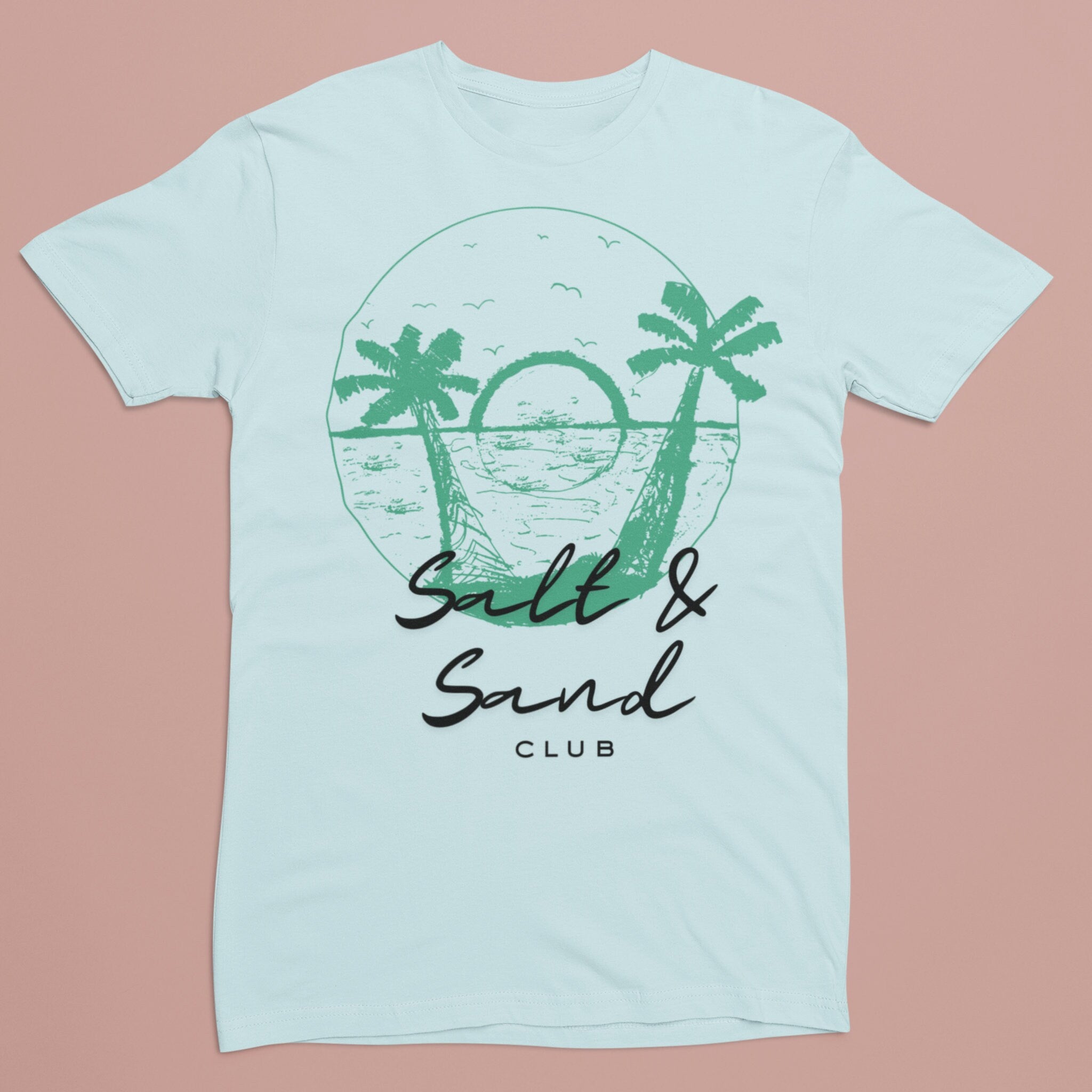 Light Blue custom tee shirt features a unique green 'Salt & Sand Club' design on the back, perfect for beachwear enthusiasts looking for stylish and personalized summer fashion.