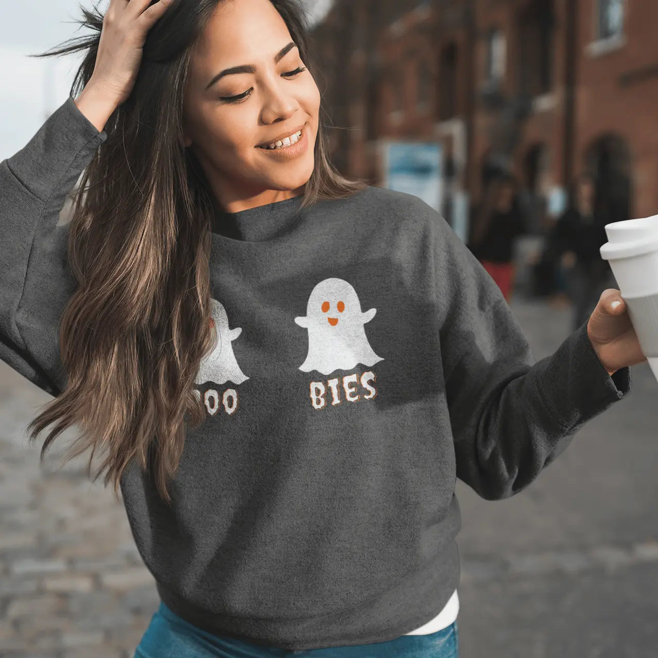 Woman wearing charcoal heather "Boo Bies" Halloween sweatshirt with coffee - funny ghost boobs sweater perfect for Halloween parties and spooky season