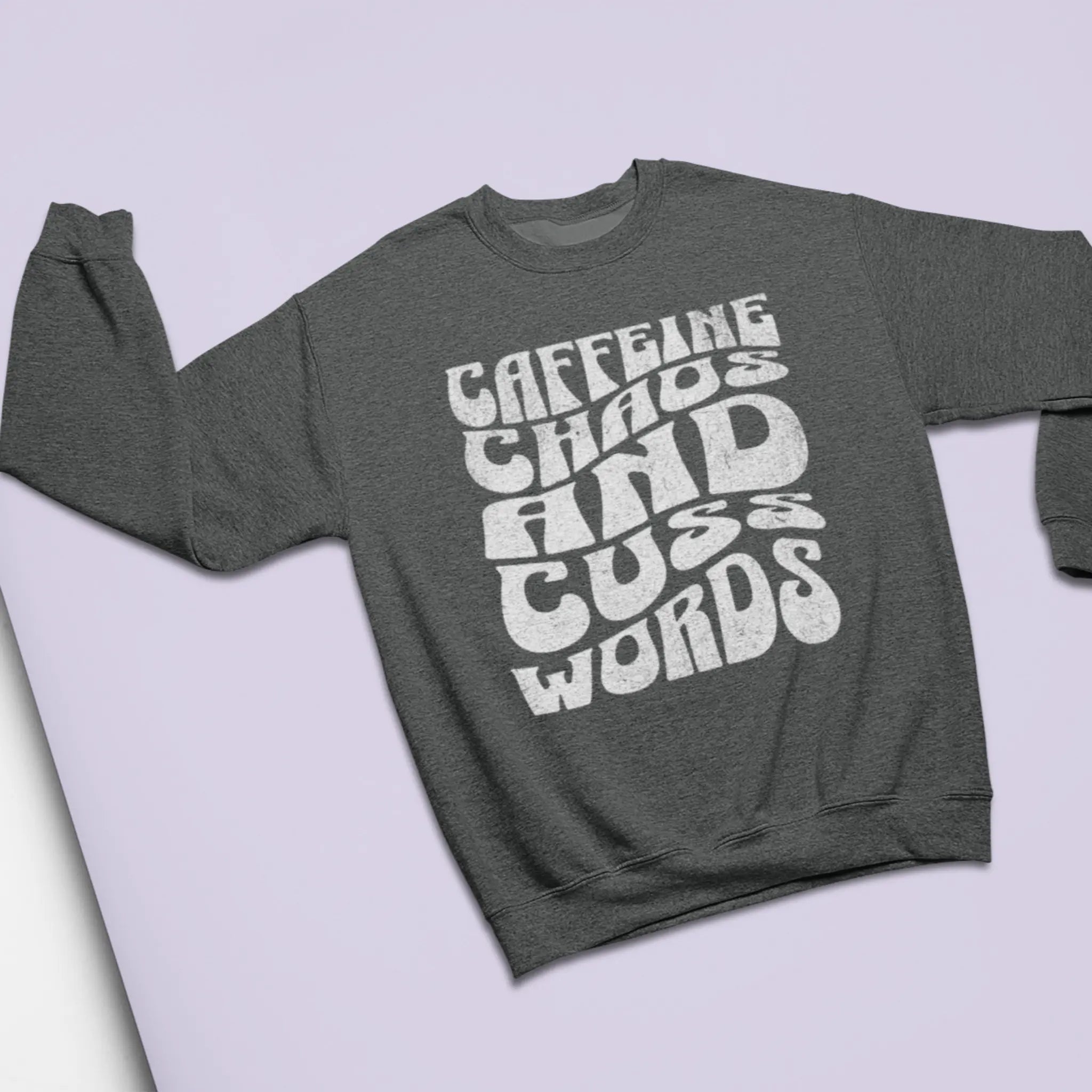 Heather gray "Caffeine Chaos And Cuss Words" crewneck sweatshirt flat lay with retro typography - funny mom sweater for coffee-addicted parents surviving on caffeine