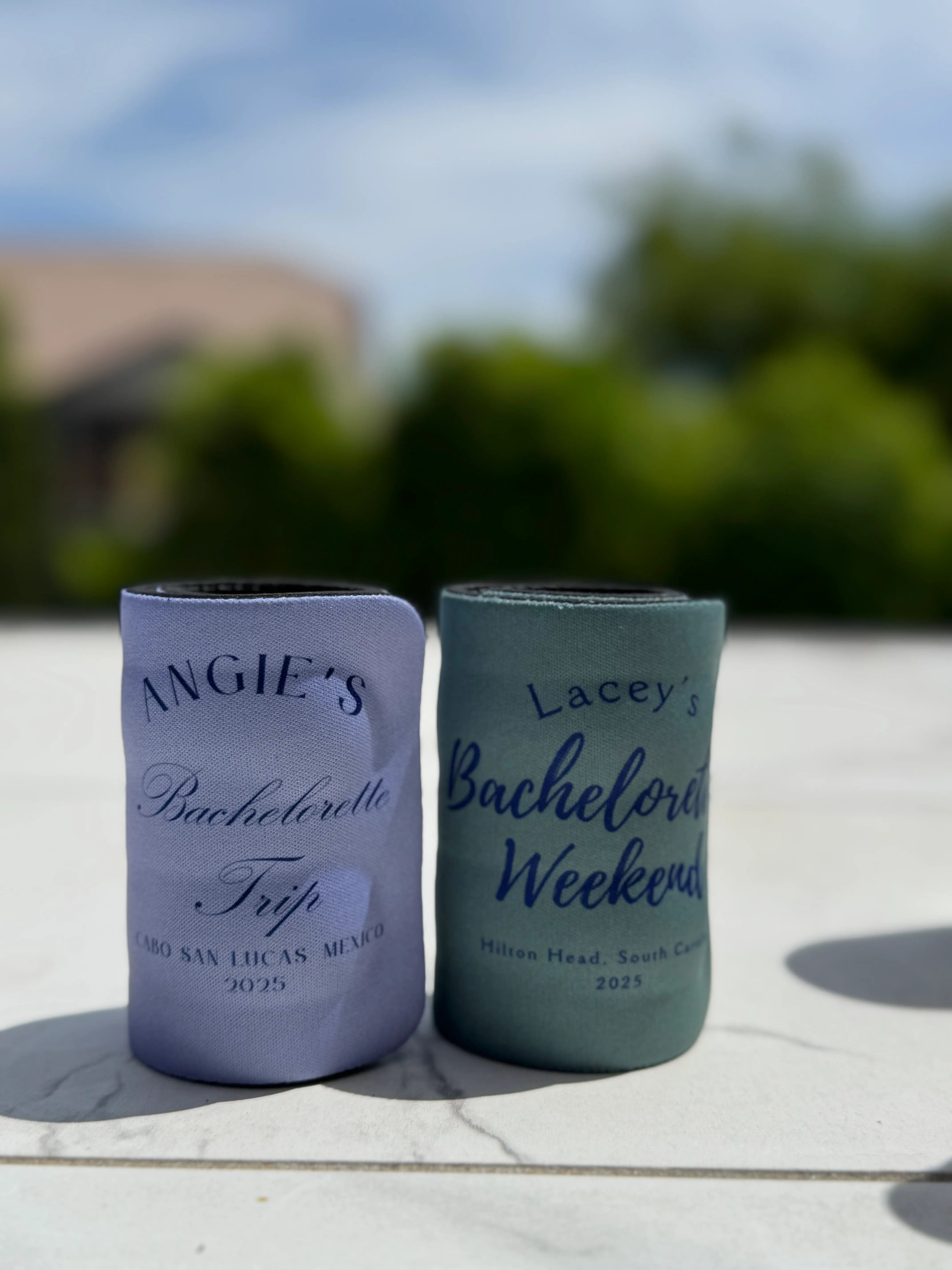 Two custom bachelorette slap wrap koozies side by side - "Angie's Bachelorette Trip" and "Lacey's Bachelorette Weekend" personalized with names and locations