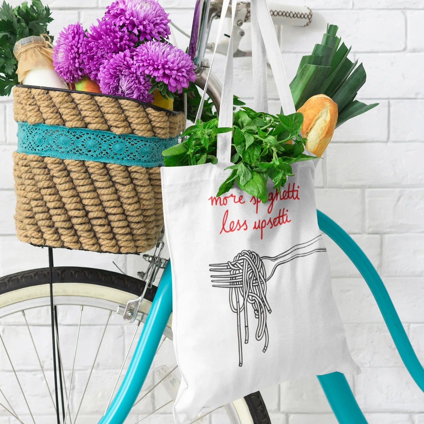 Funny Italian saying 'More Spaghetti Less Upsetti' on White tote hanging on bike filled with groceries.