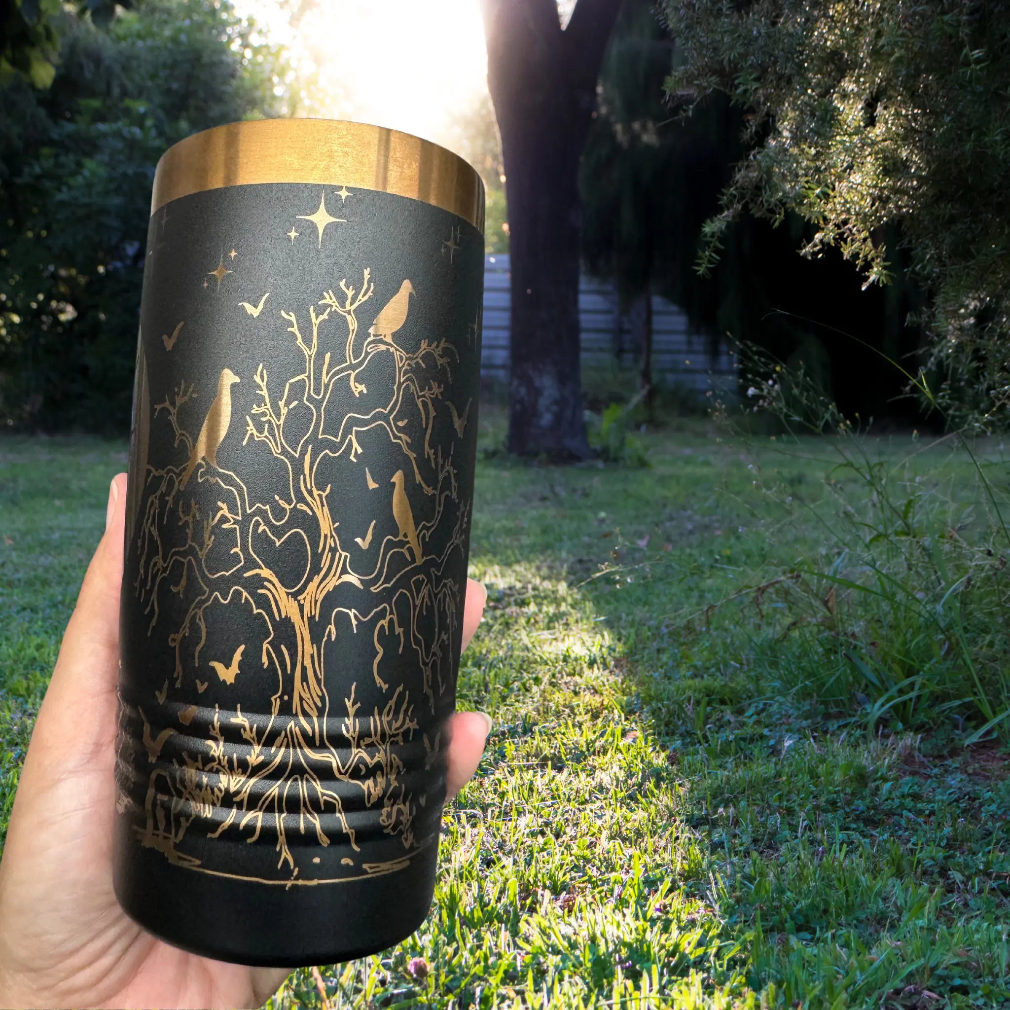 20oz Halloween tumbler in black with rose gold detailed laser engraving of haunted scene with stars and bats - insulated cup for spooky season