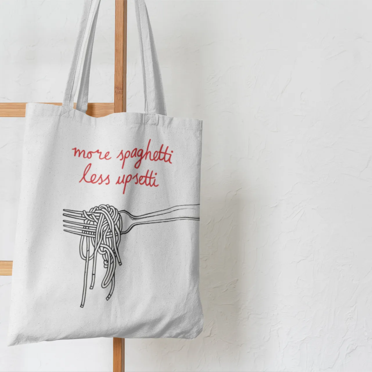 Tote bag with spaghetti design and text on a white background