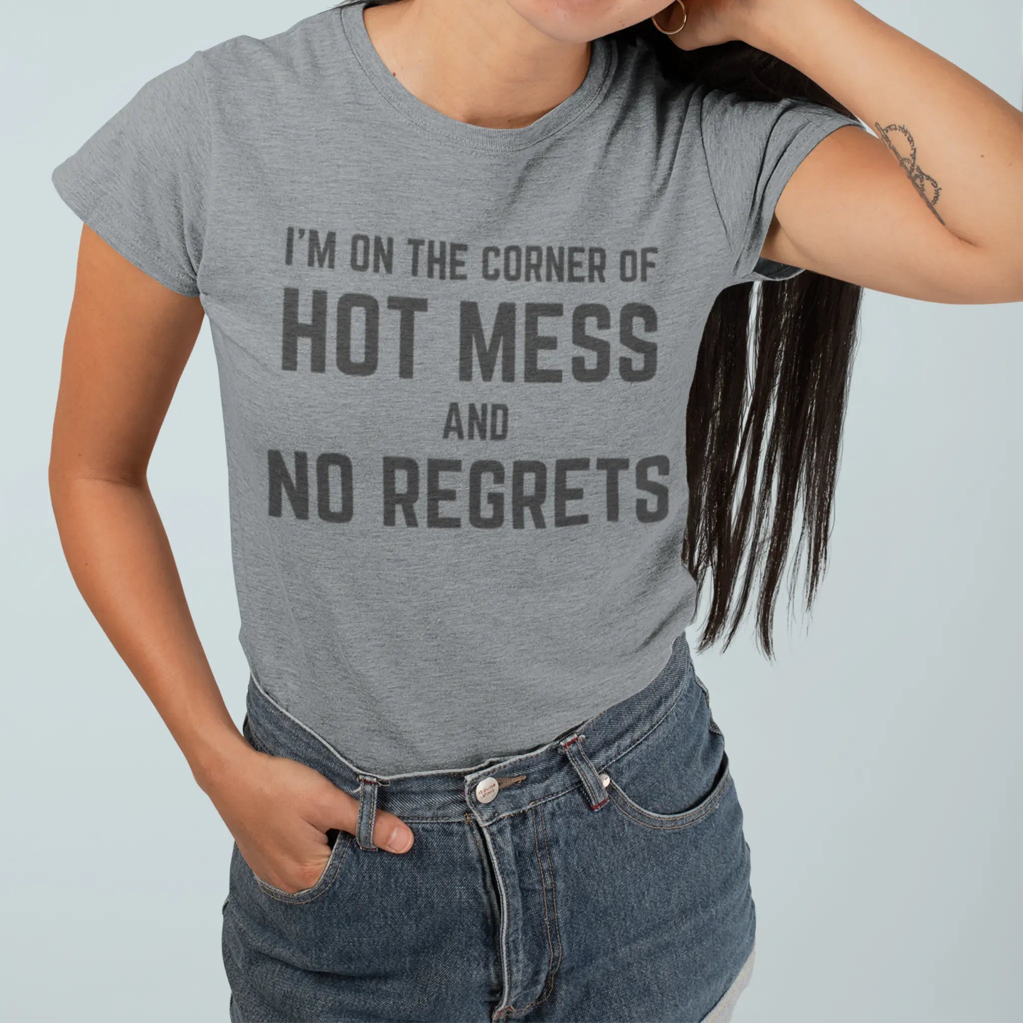 Woman wearing heather light gray "I'm On The Corner Of Hot Mess And No Regrets" t-shirt - funny sarcastic tee for unapologetic hot mess lifestyle
