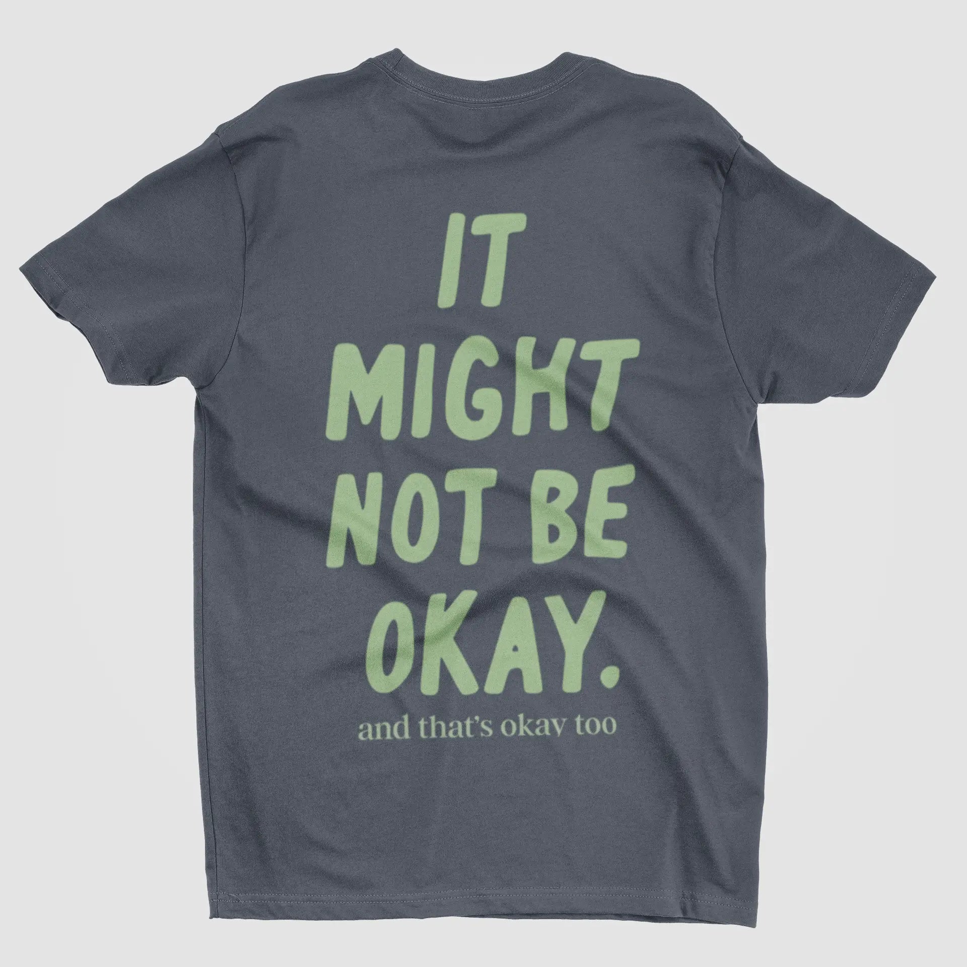 Flat lay of comfort tee with "It Might Not Be Okay" message - snarky mental health humor shirt by After Five Designs