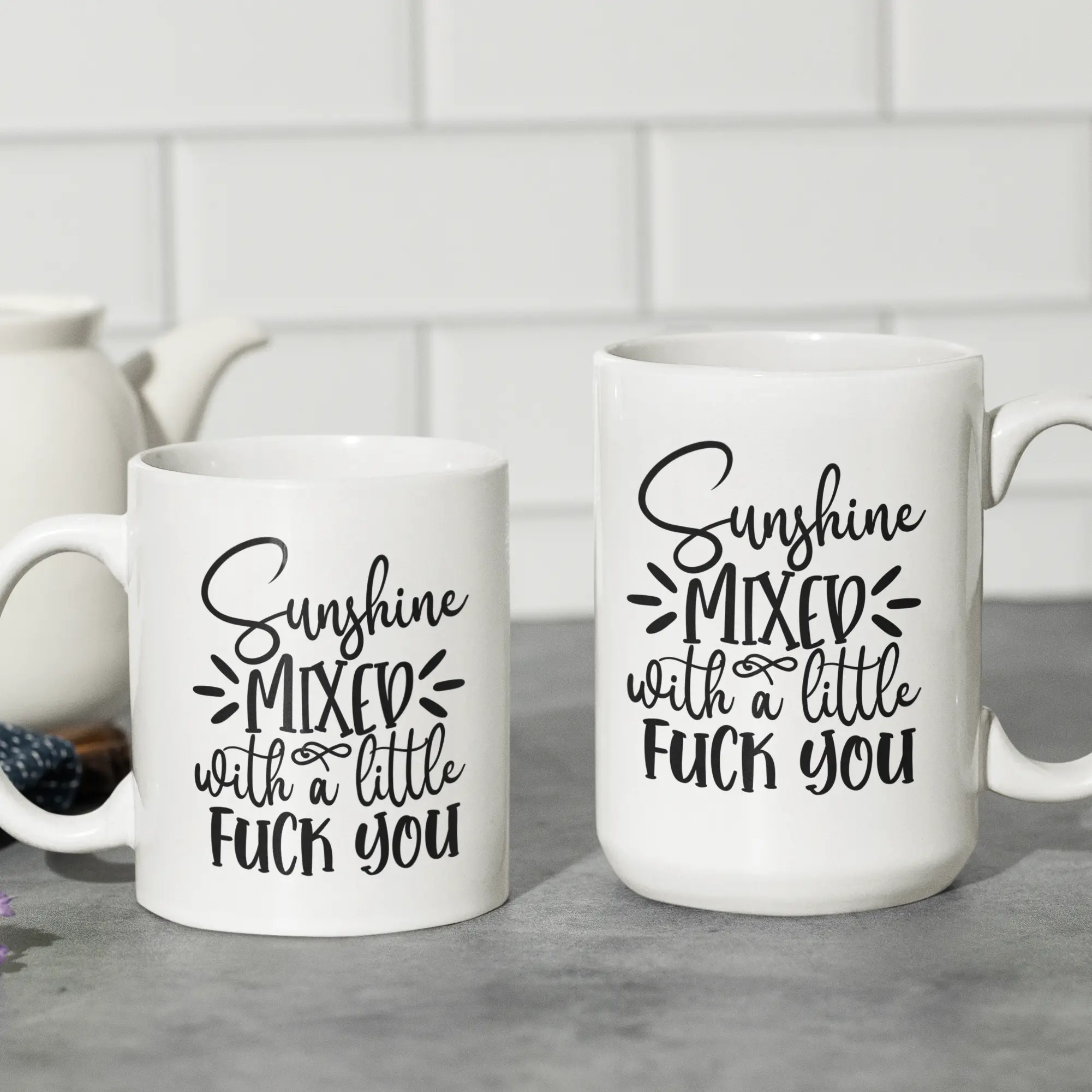 Two different sized coffee mugs with colored handles placed together - two-toned ceramic cups perfect for coffee and tea lovers