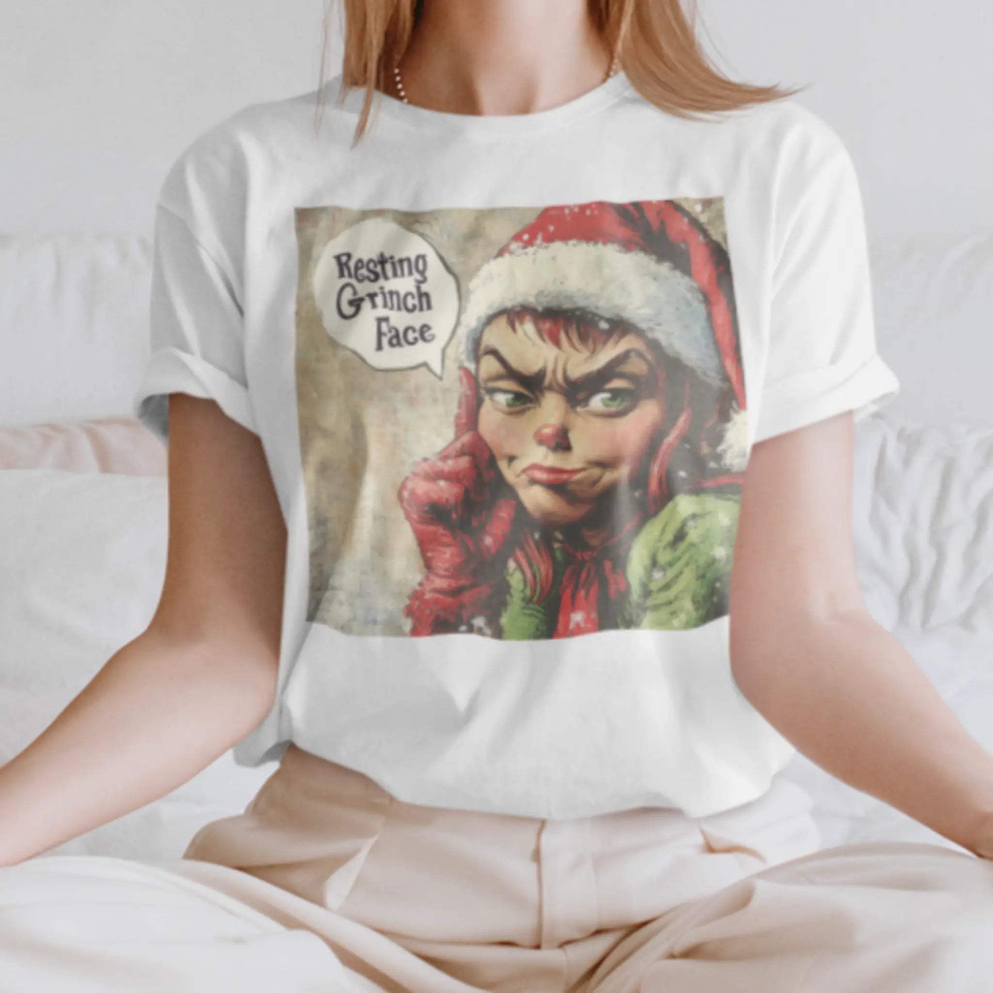 Woman wearing white "Resting Grinch Face" t-shirt - funny Christmas shirt with grumpy Grinch design for holiday haters and sarcastic humor