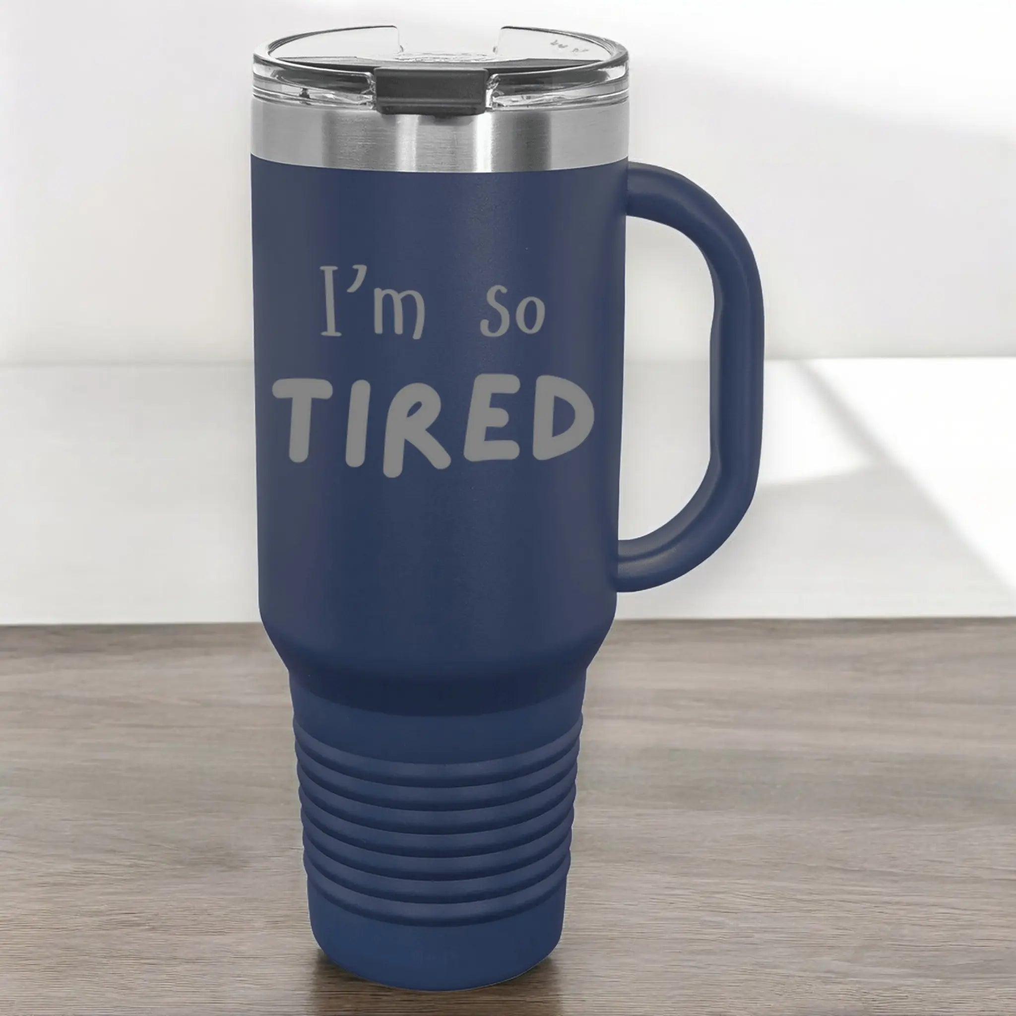 Hand holding 40oz laser etched "I'm So Tired" tumbler with straw - tired parent insulated cup for those running on empty