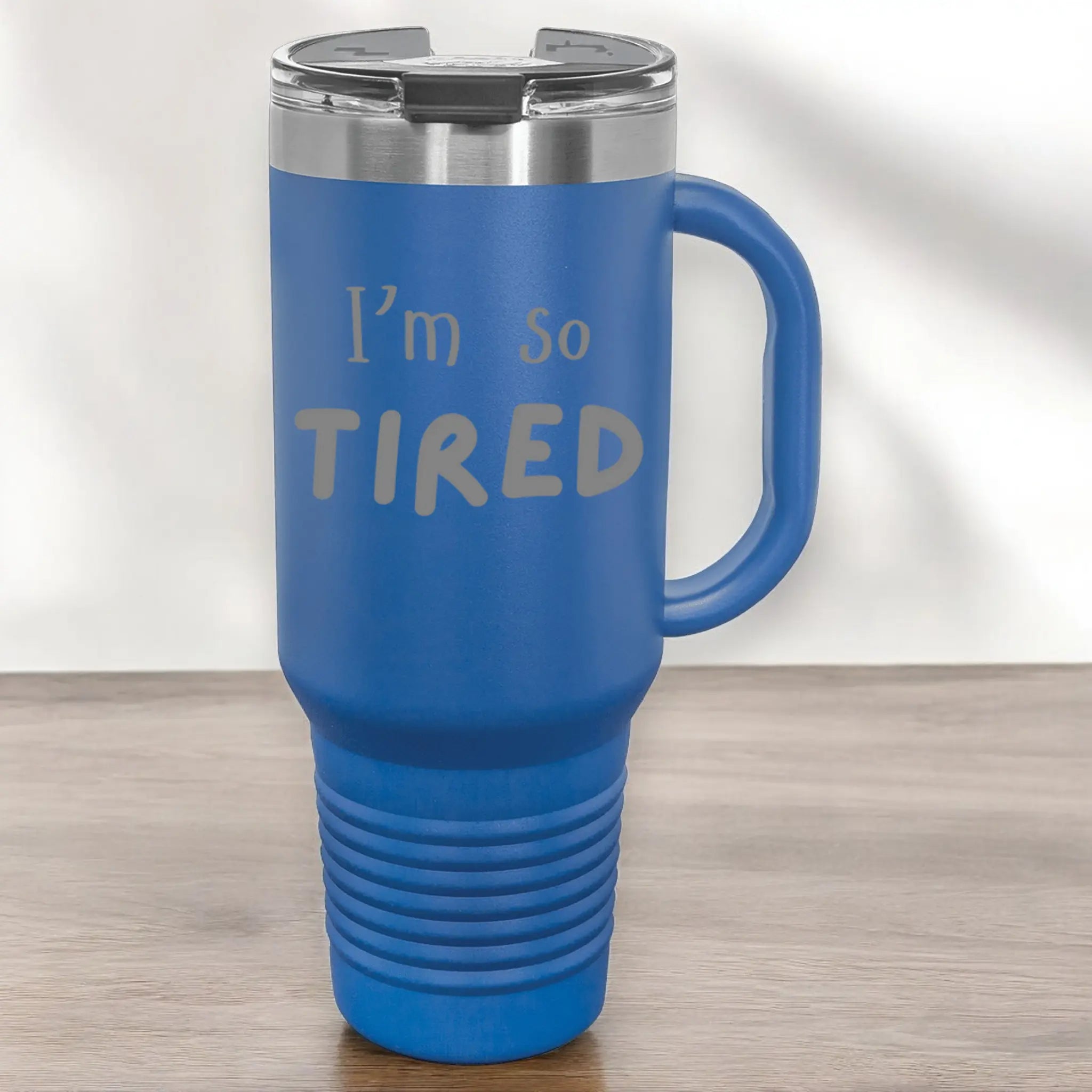 Hand holding 40oz laser engraved "I'm So Tired" tumbler - lifestyle exhausted parent cup with handle for perpetual fatigue