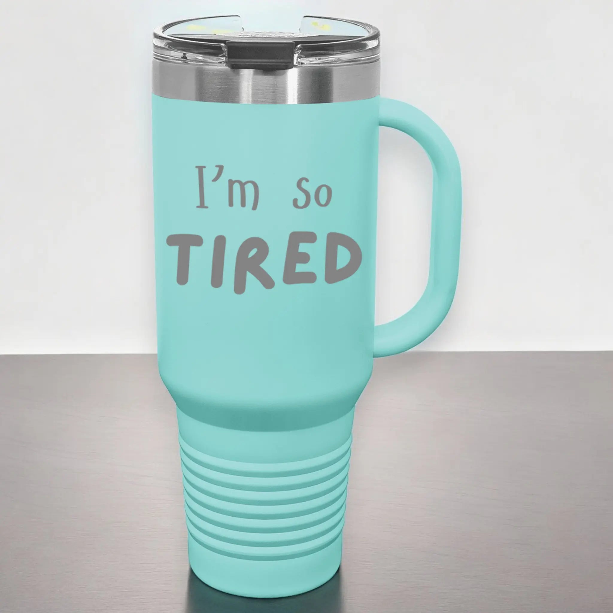 Hand holding 40oz laser engraved "I'm So Tired" tumbler - lifestyle exhausted cup with handle for chronically sleep-deprived people