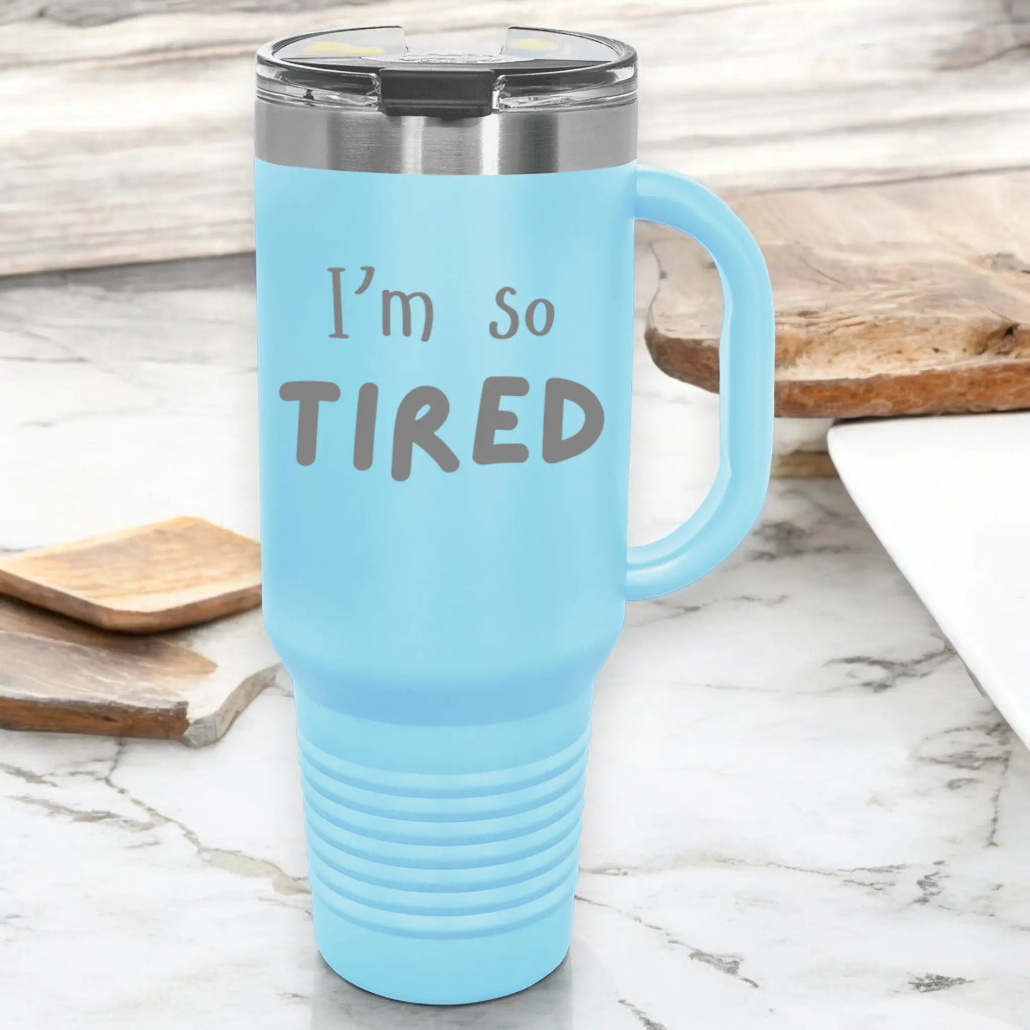 Hand holding 40oz laser engraved "I'm So Tired" tumbler - lifestyle exhausted cup with handle for chronically tired people
