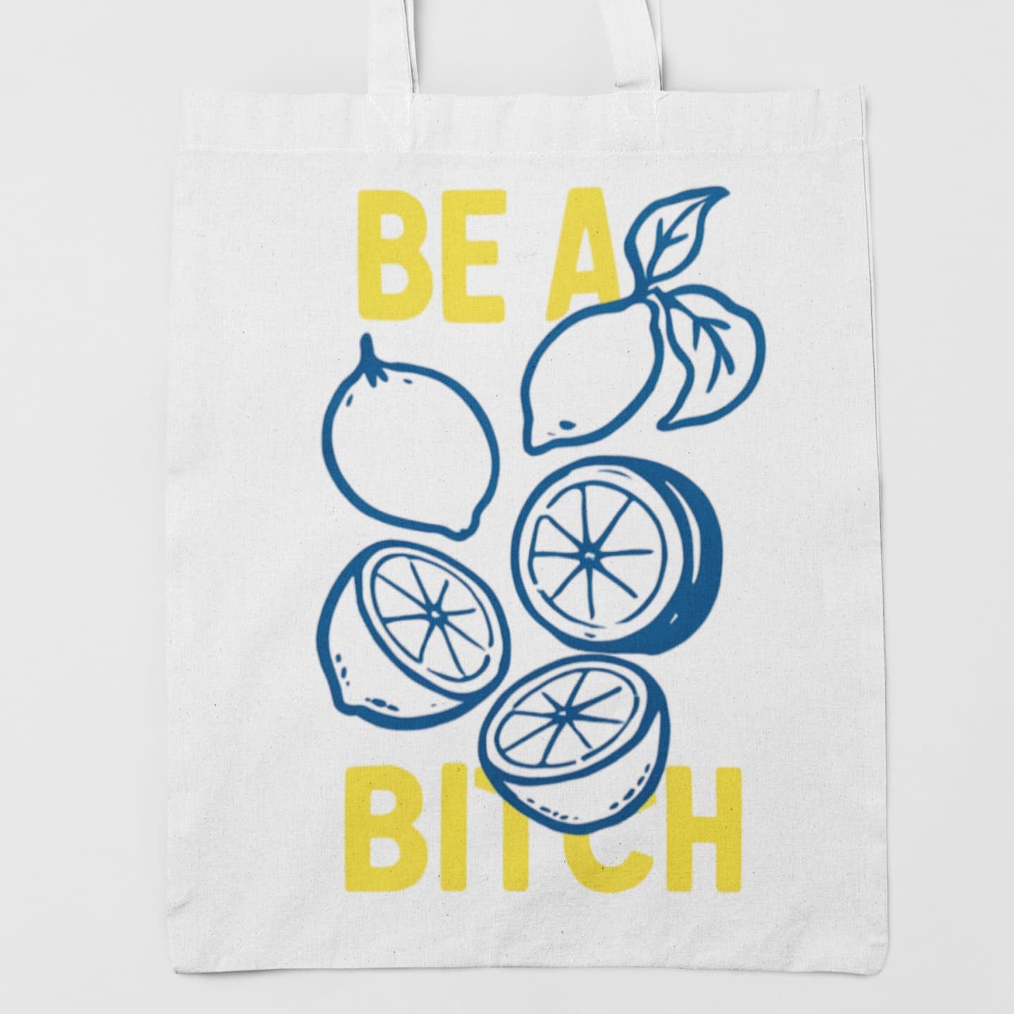 White tote bag with lemon design and text on a white background