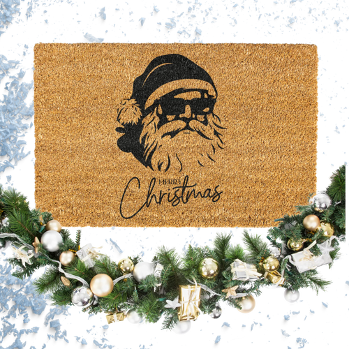 Doormat with Santa Claus design and 'Merry Christmas' text, surrounded by festive decorations on a snowy background.
