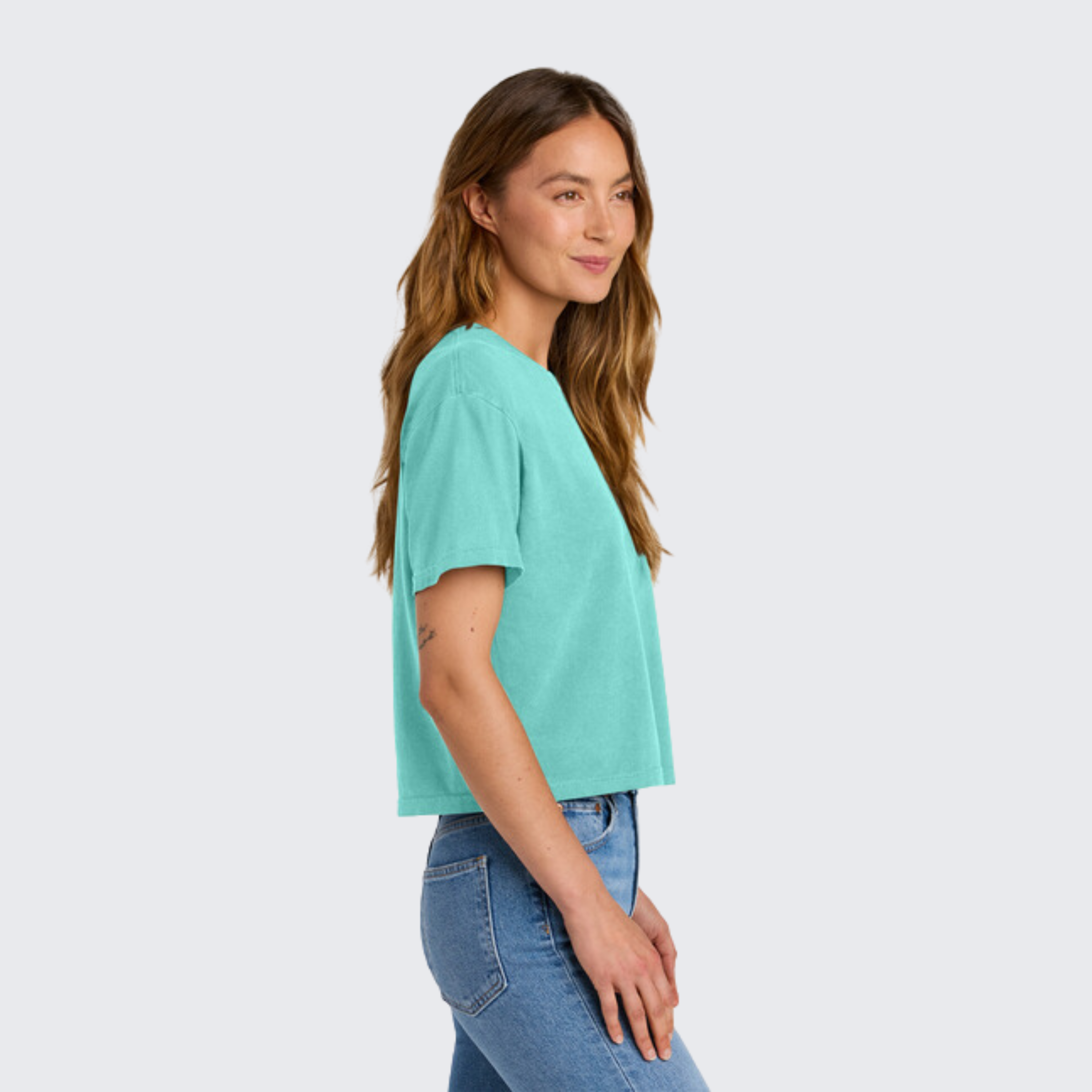 Side View of Teal boxy shirt on model Moms Against White Pants' Comfort Colors tee for sports moms tired of washing their kids' stained baseball and football pants