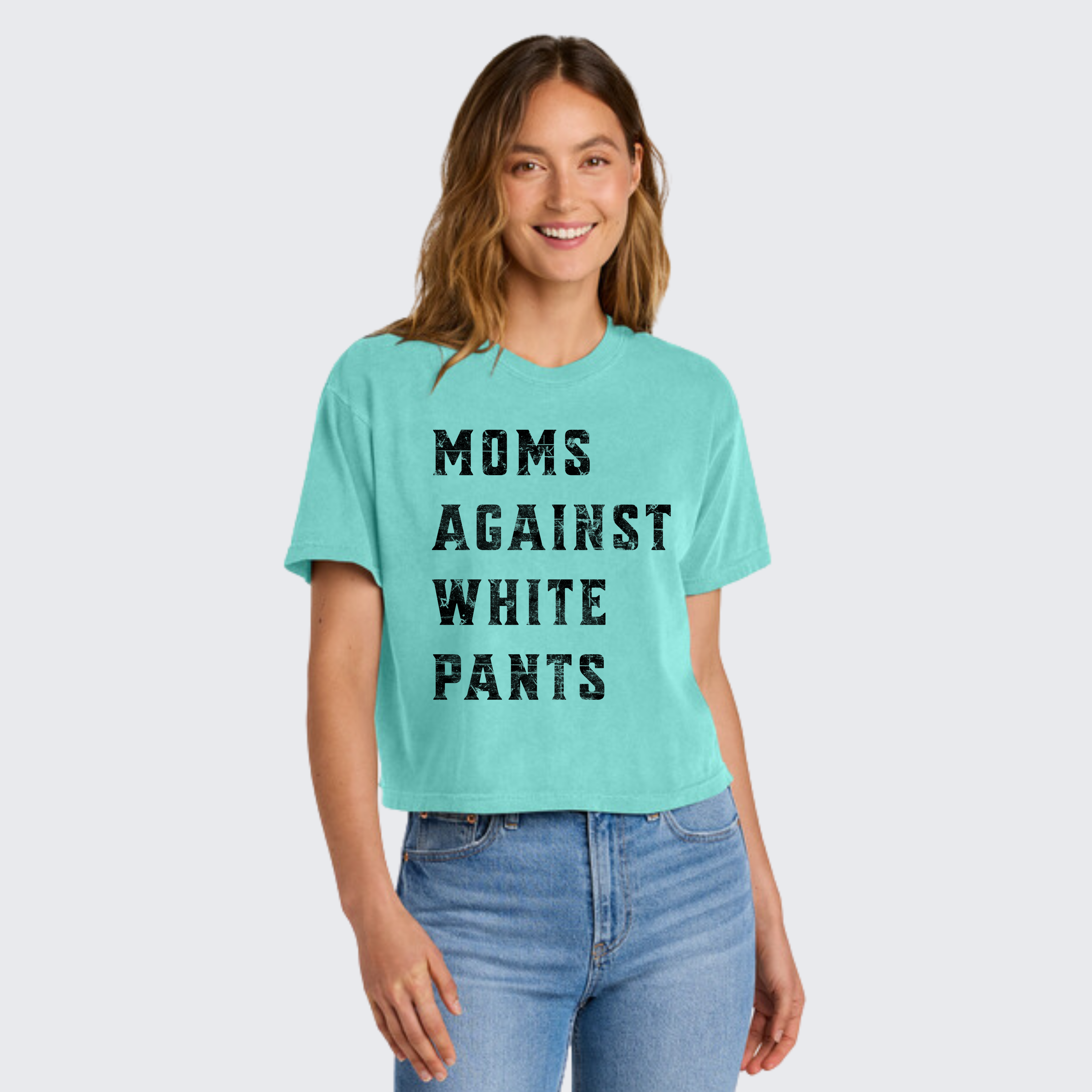 Front view of Teal boxy shirt on model Moms Against White Pants' Comfort Colors tee for sports moms tired of washing their kids' stained baseball and football pants
