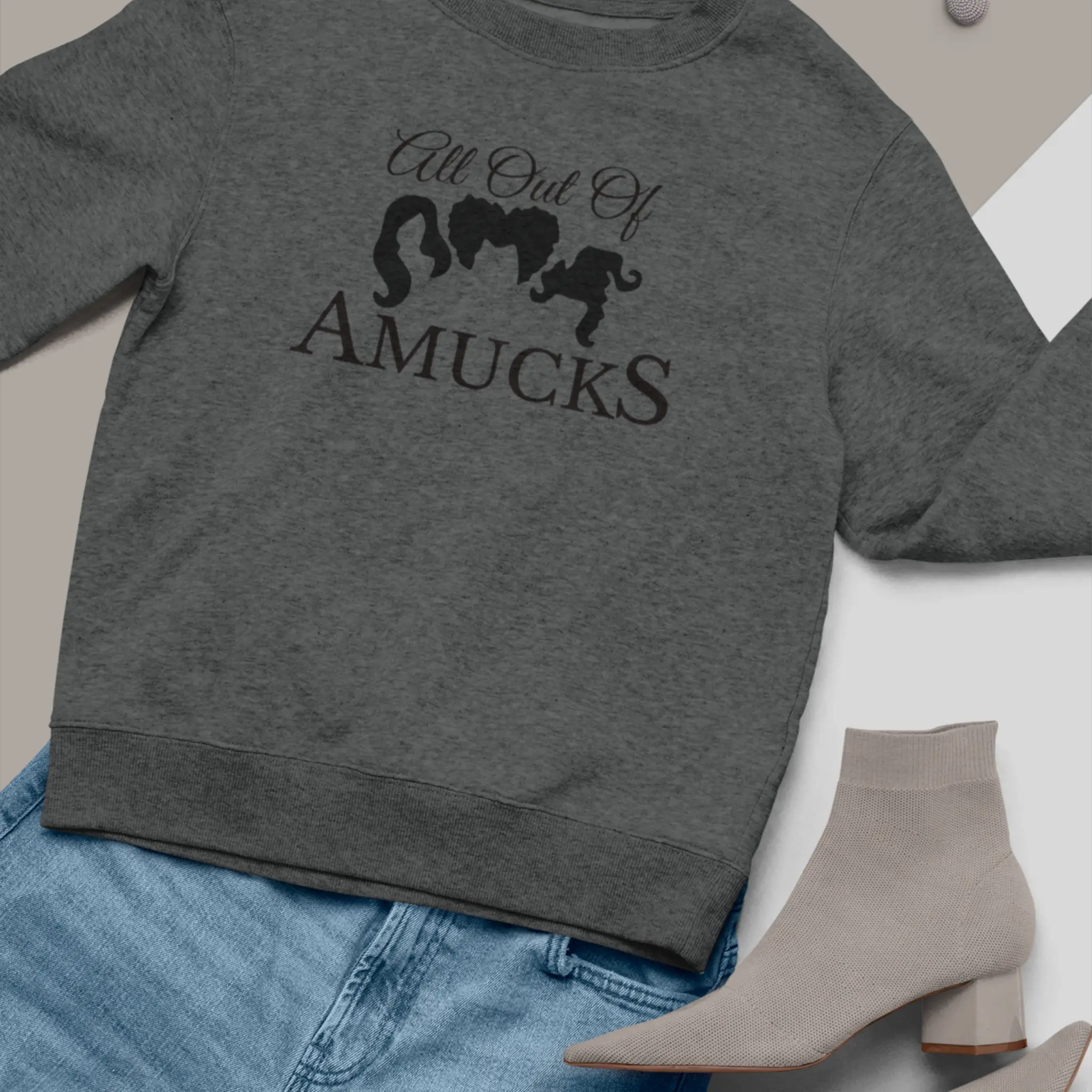 Lifestyle shot of "All Out Of Amucks" crewneck sweatshirt - Hocus Pocus Sanderson Sisters sweater perfect for Halloween parties and fall