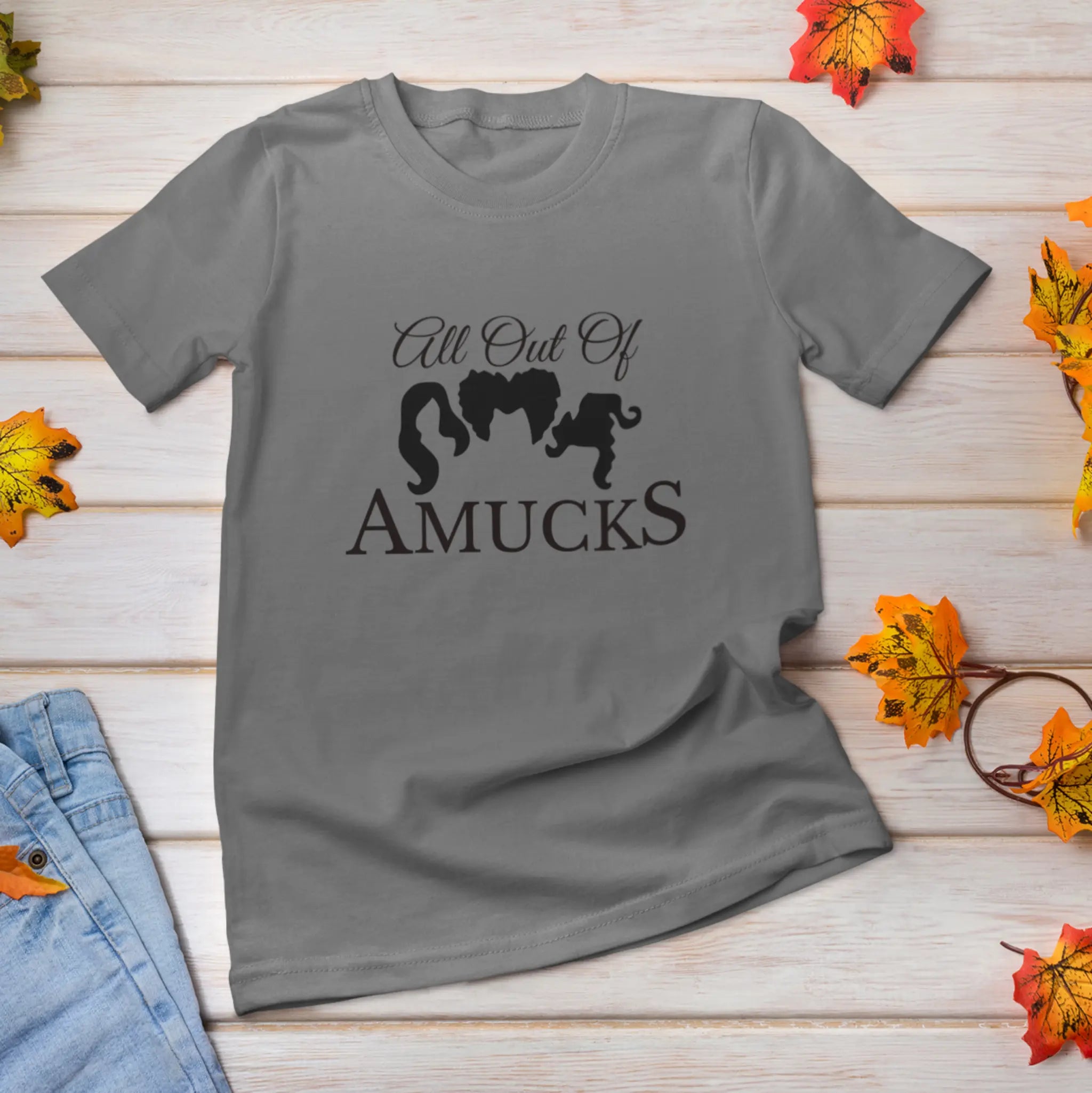 "All Out Of Amucks" burnt orange Halloween t-shirt flat lay with fall leaves - Hocus Pocus Sanderson Sisters shirt perfect for spooky season and Halloween parties