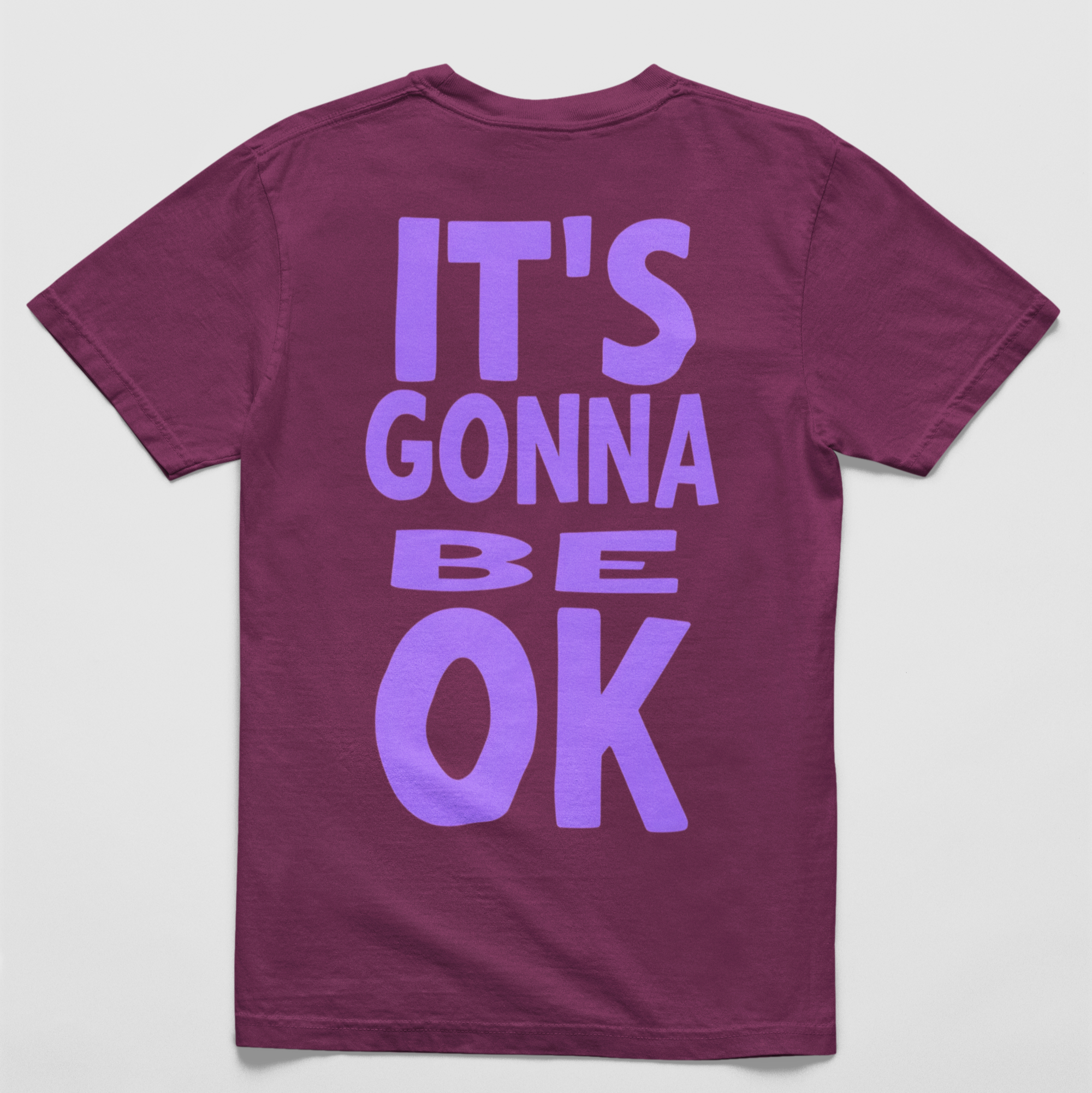 Vineyard Oversized black tee with "It’s Gonna Be OK" printed in bold purple text on the back, styled for casual and confident comfort.