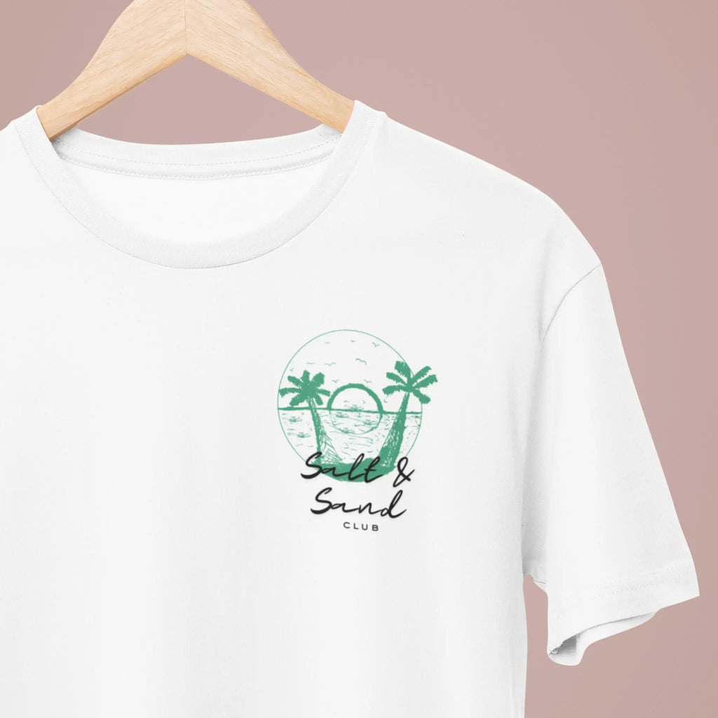 Minimalist left chest “Salt & Sand Club” graphic on white tee with palm trees and ocean sunset