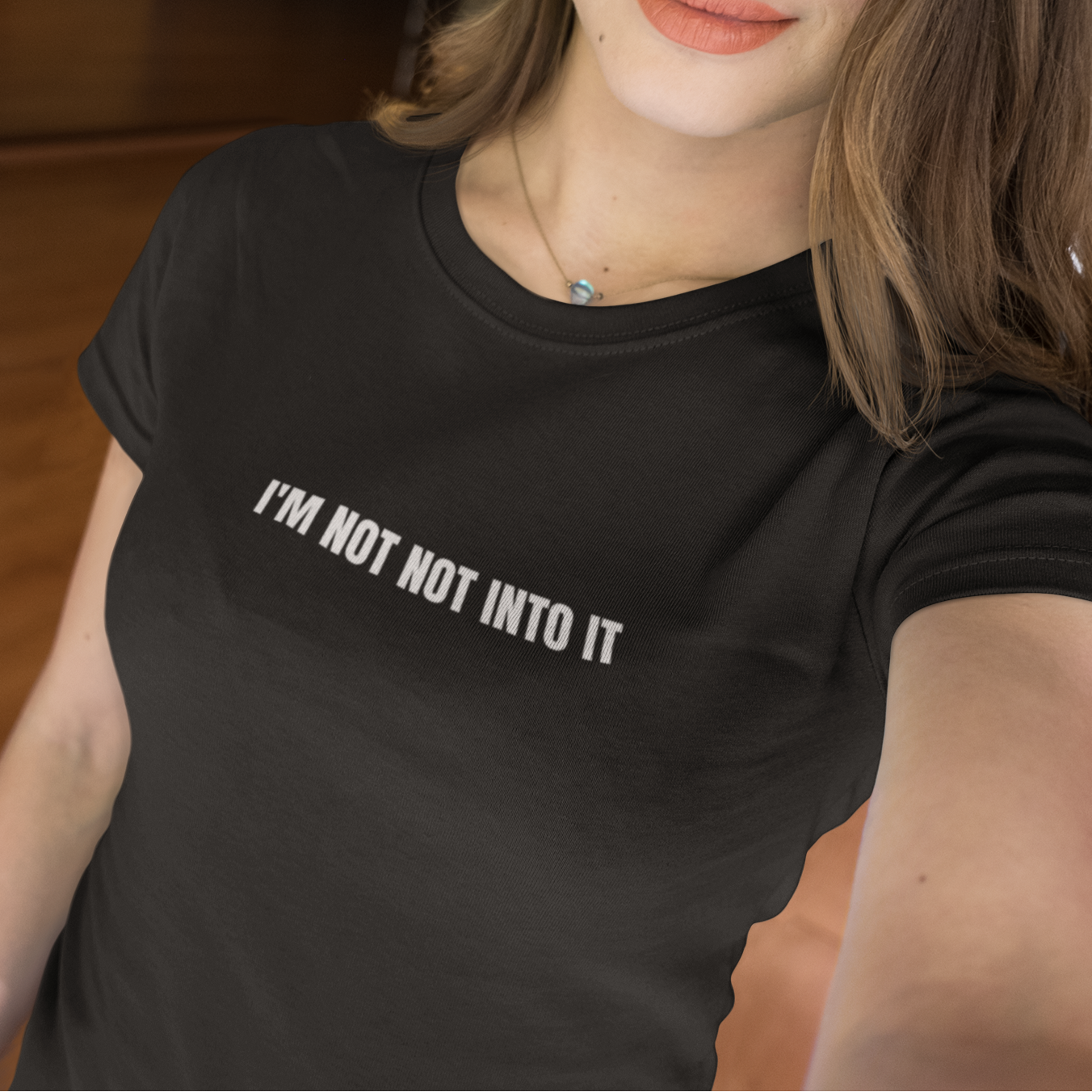 Black 'I'm Not Not Into It' soft black tee featuring bold text design, perfect for casual and stylish everyday wear