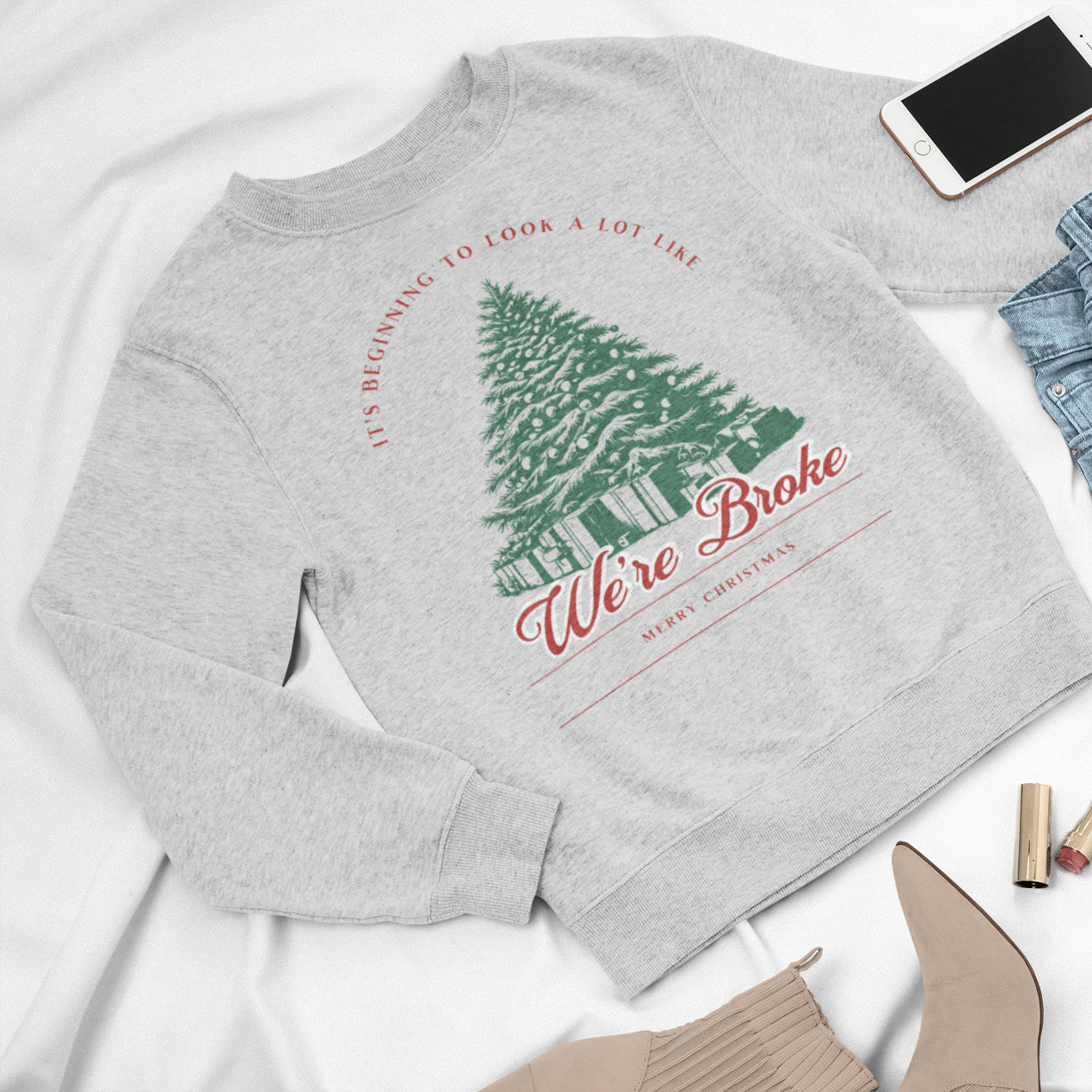 Christmas crewneck sweatshirt with the phrase 'It's Beginning to Look a Lot Like We're Broke,' featuring a festive Christmas tree design, perfect for humorous holiday style