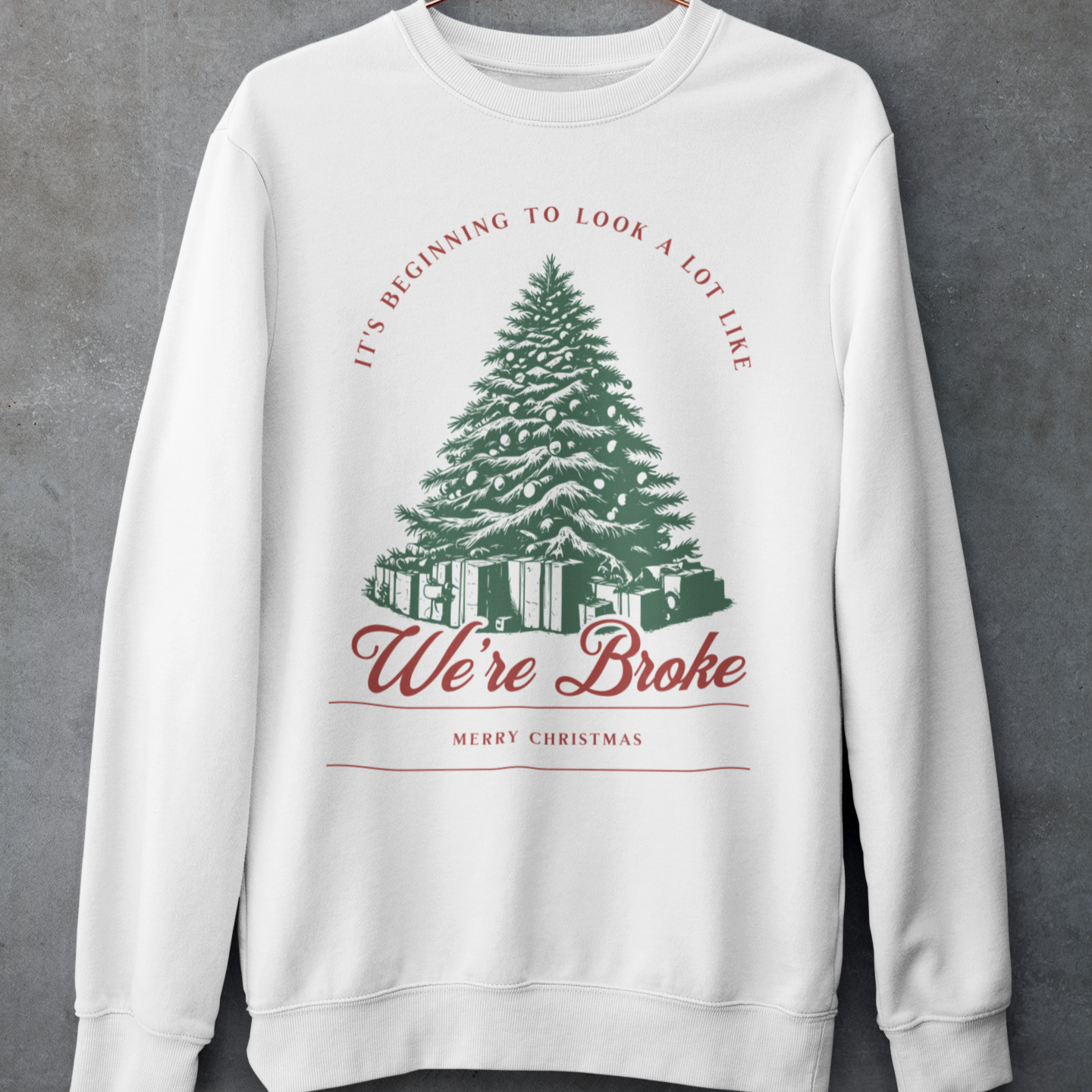 Christmas crewneck sweatshirt with the phrase 'It's Beginning to Look a Lot Like We're Broke,' featuring a festive Christmas tree design, perfect for humorous holiday style hanging 