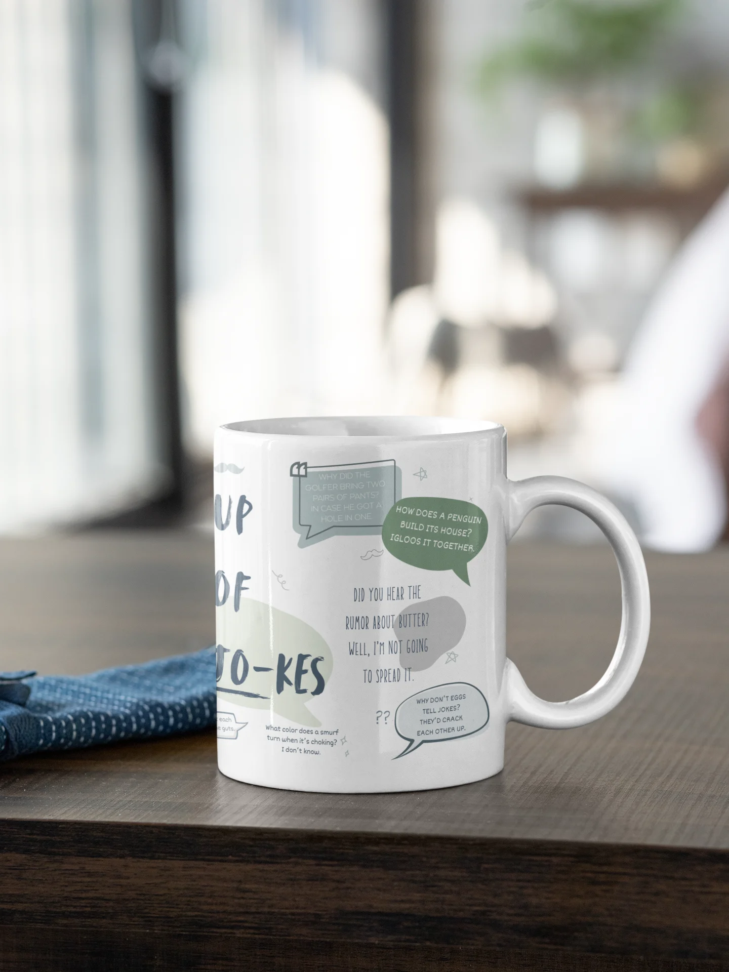 White mug with text and graphics on a wooden surface