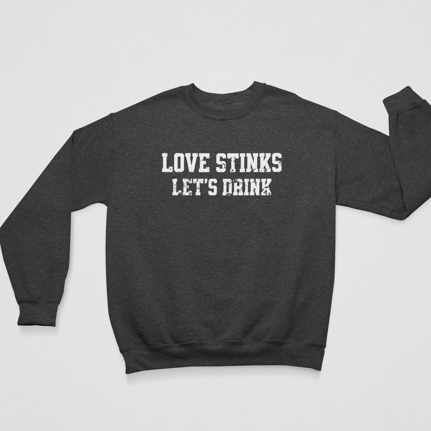 Dark Gray Flat Lay 'Love Stinks, Let's Drink' crewneck sweatshirt with bold white distressed lettering, perfect for cozy anti-Valentine's style.