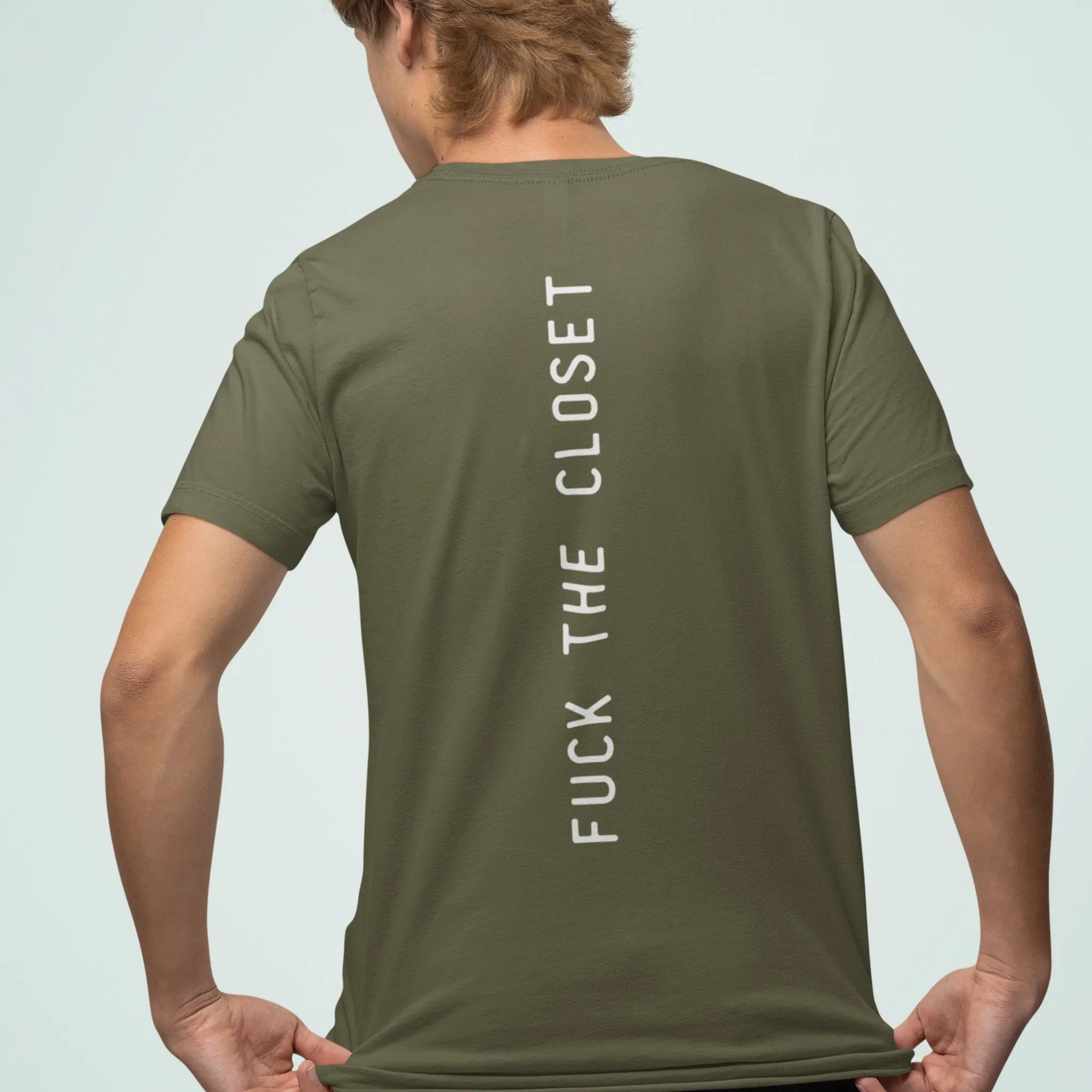 Man wearing olive green unisex crewneck t-shirt with small “fuck the closet” text on chest, LGBTQ pride ally shirt