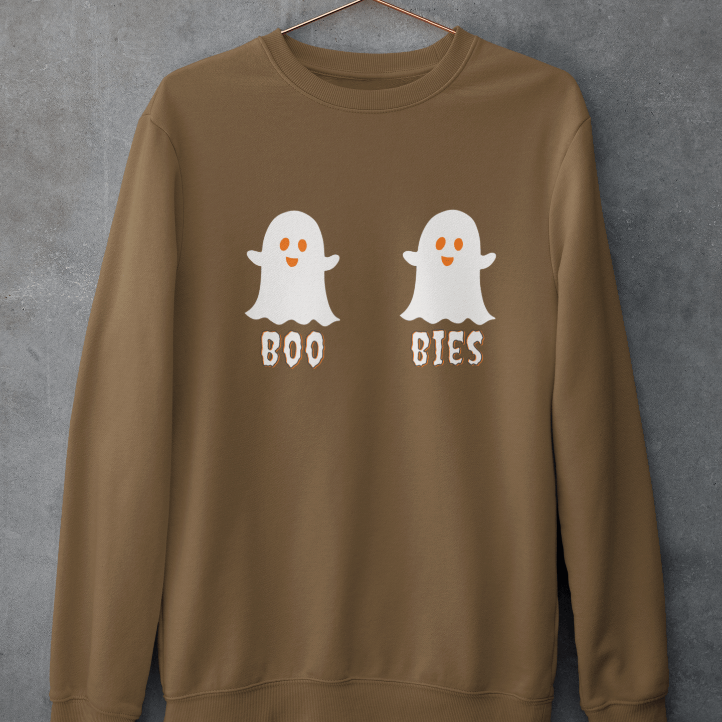 Brown cozy Halloween sweatshirt featuring two cute ghost illustrations with the playful text "BOO BIES," hanging against a gray background, perfect for festive casual wear.
