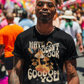 Black graphic t-shirt with “Hate Doesn’t Look Good On You” text and retro mushroom design, positive message tee