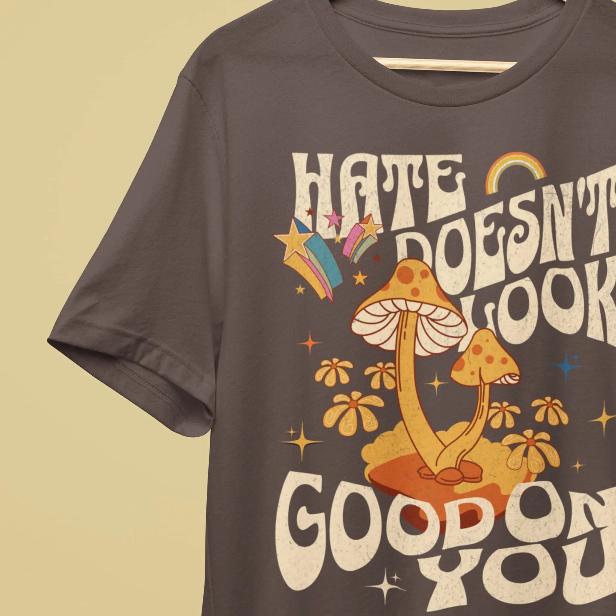 “Hate Doesn’t Look Good On You” shirt with cute mushrooms and rainbow accents, kindness quote graphic tee