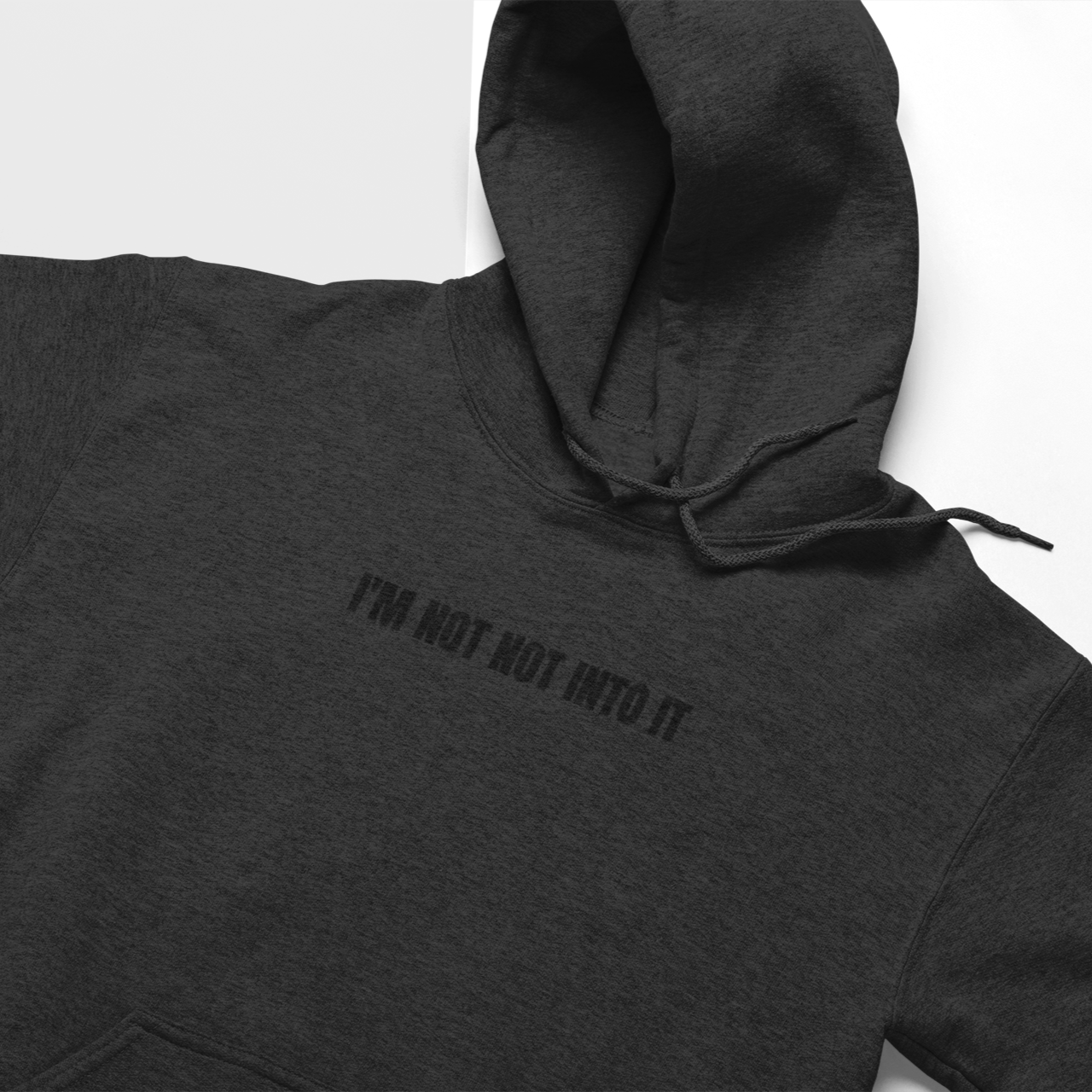 Dark Gray lay flat 'I'm Not Not Into It' black soft hoodie featuring a bold and playful text design, perfect for casual and cozy wear.