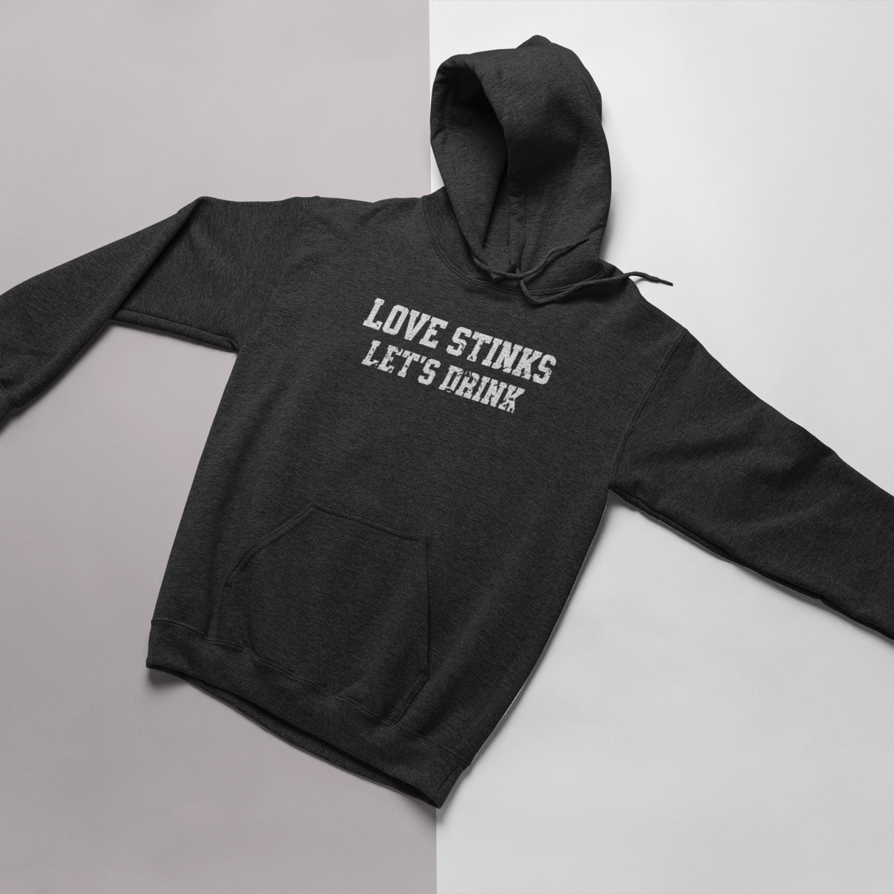 Dark Heather Gray Valentine's hoodie with the phrase 'Love Stinks, Let’s Drink,' perfect for cozy anti-Valentine's Day vibes.