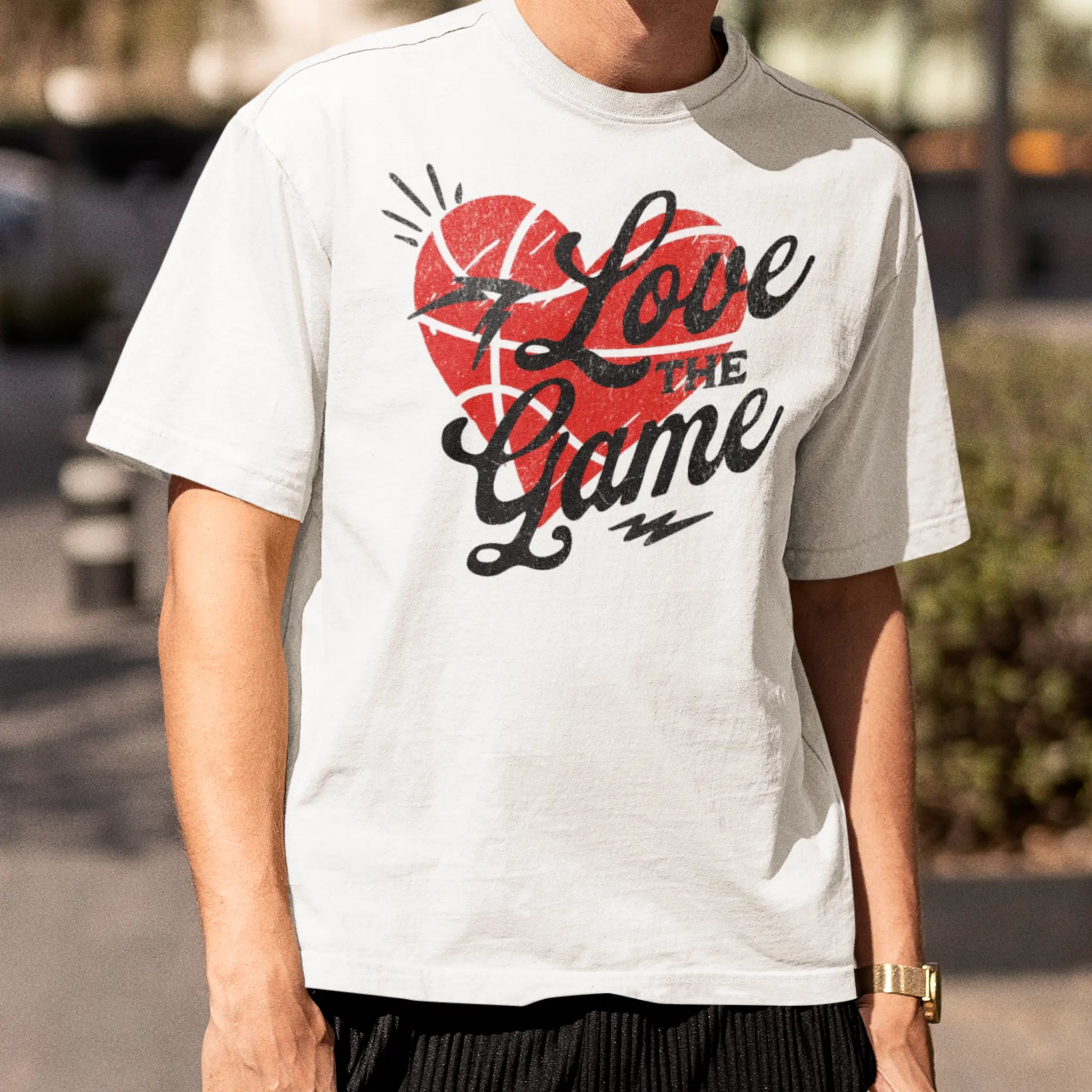 Unisex white crewneck tee featuring “Love the Game” text with red heart and lightning accents, sports lover shirt