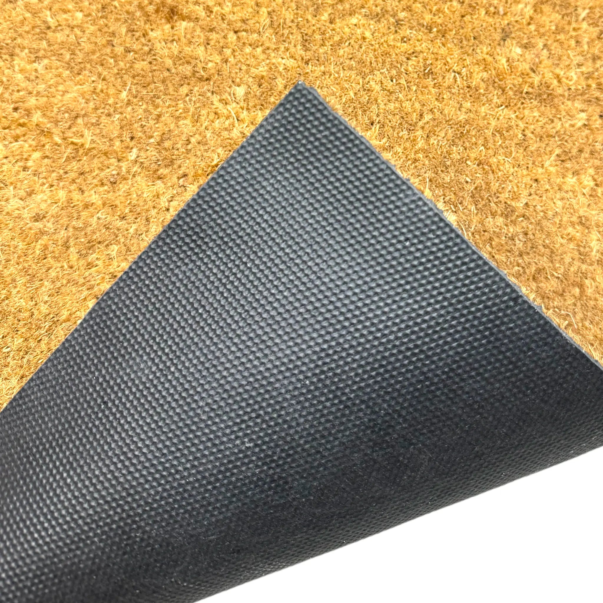 Close-up of a doormat with a textured black border and beige surface