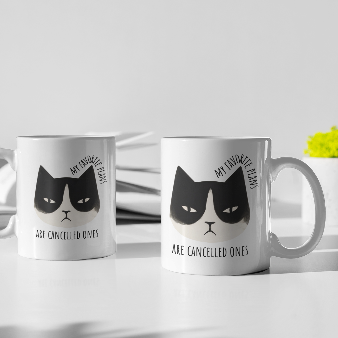 two 15 oz ceramic mug with cartoon grumpy cat and “My favorite plans are cancelled ones” text