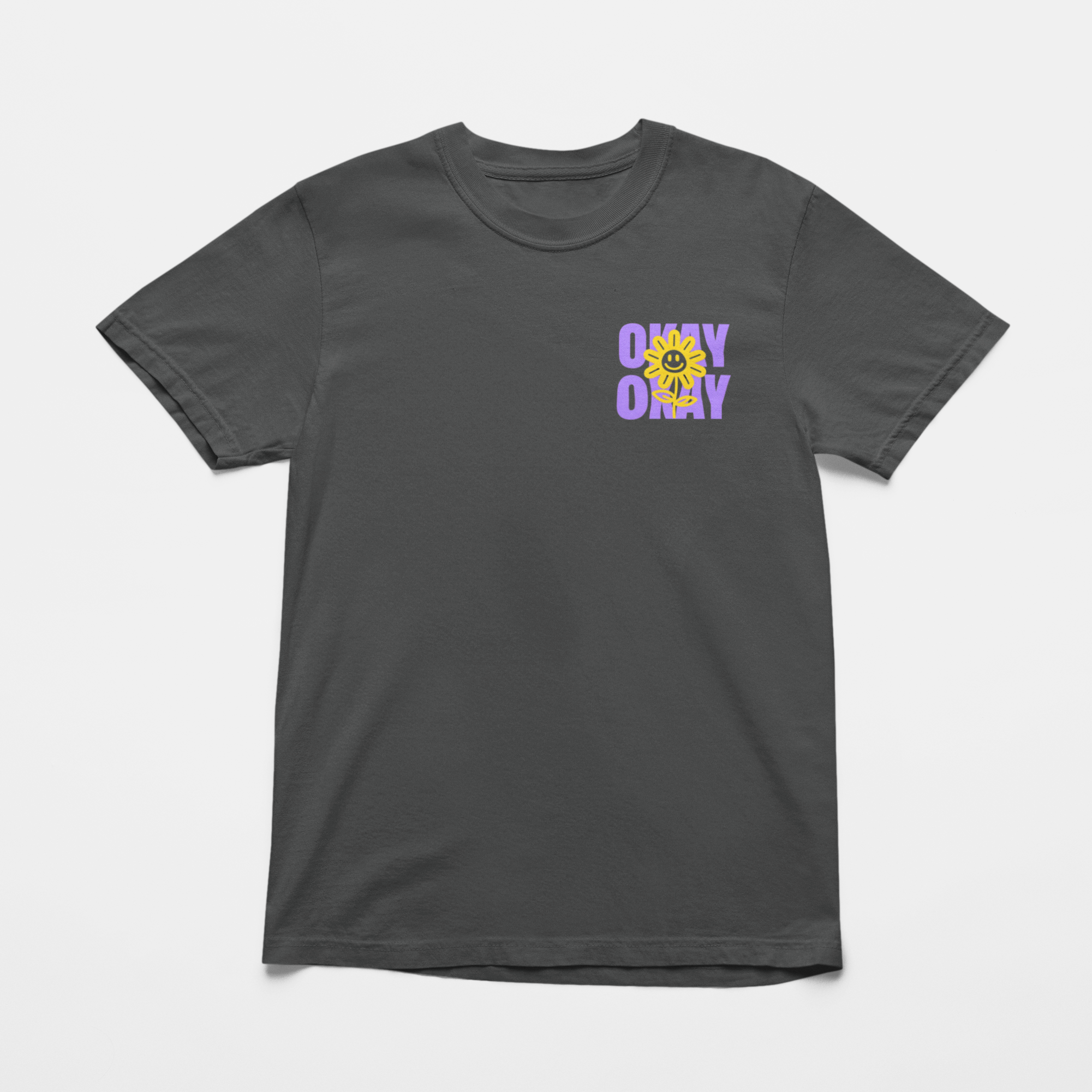 Oversized charcoal front tee with "It’s Gonna Be OK" printed in bold purple text on the back, styled for casual and confident comfort.