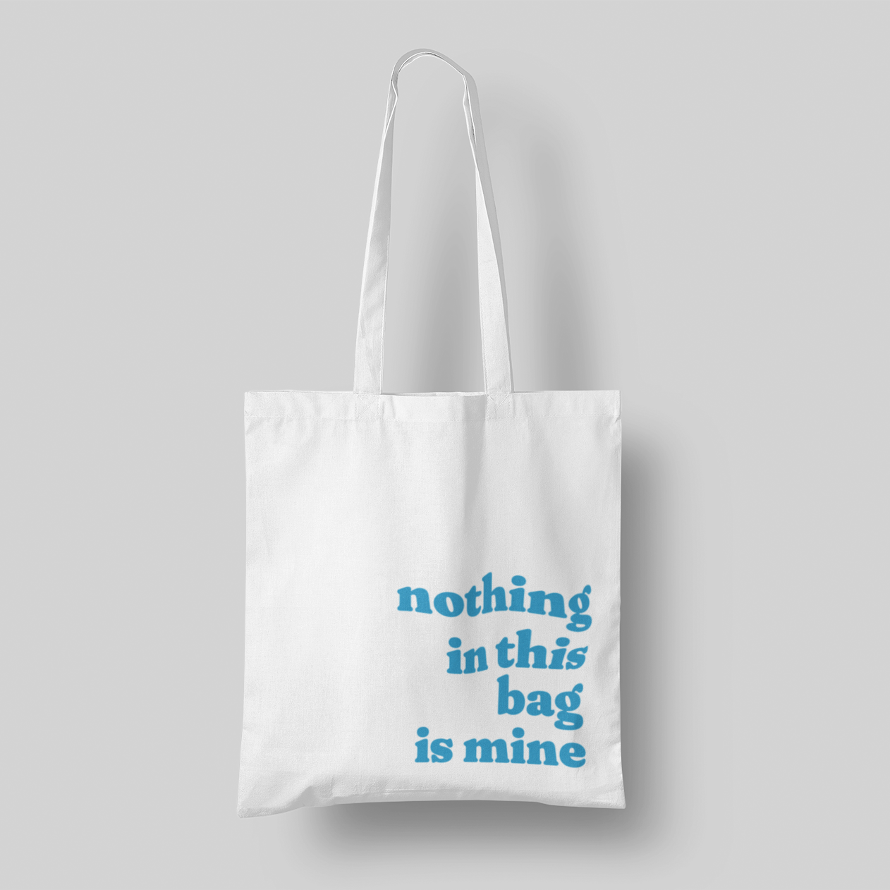 Blue text 'Nothing in This Bag is Mine' cotton canvas tote, 15x16 inches, with multi-color text, perfect for hauling everyone else’s stuff