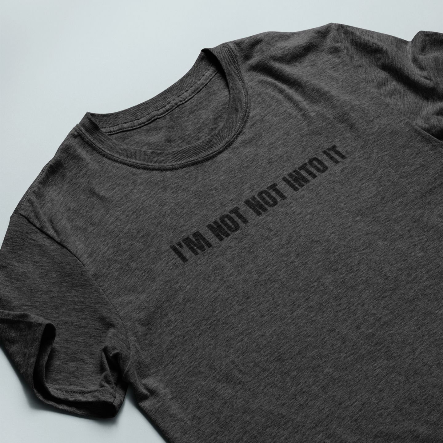 'I'm Not Not Into It' soft heather gray tee featuring bold text design, perfect for casual and stylish everyday wear