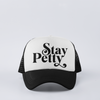 Black funny trucker hat with ‘Stay Petty’ design, featuring a snapback closure and mesh back for comfort.
