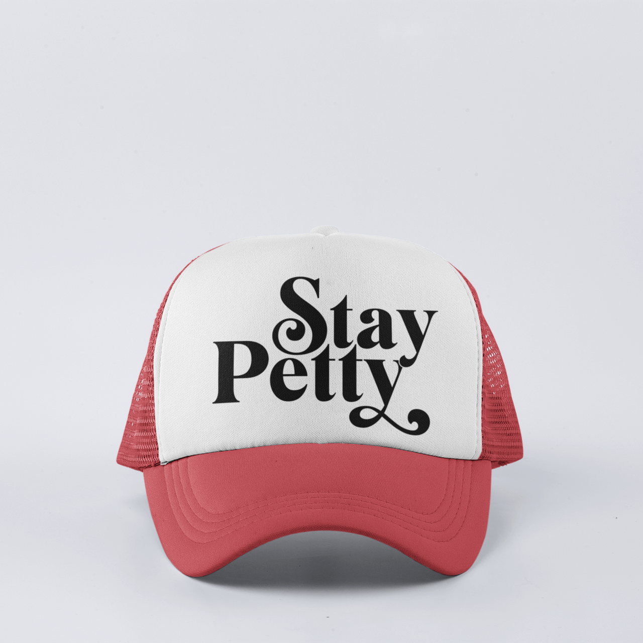 Red funny trucker hat with ‘Stay Petty’ design, featuring a snapback closure and mesh back for comfort.